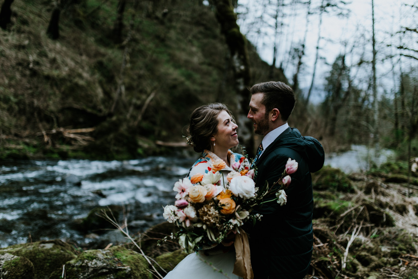 Allison and Lennie hug next to a stream. Elopement photography at Columbia River Gorge by Sienna Plus Josh.