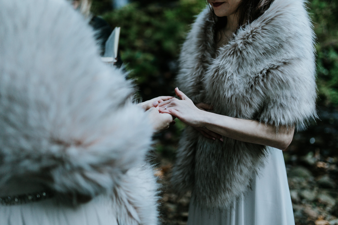 Tiffany and Hayley exchange rings. Elopement photography at the Columbia River Gorge by Sienna Plus Josh.