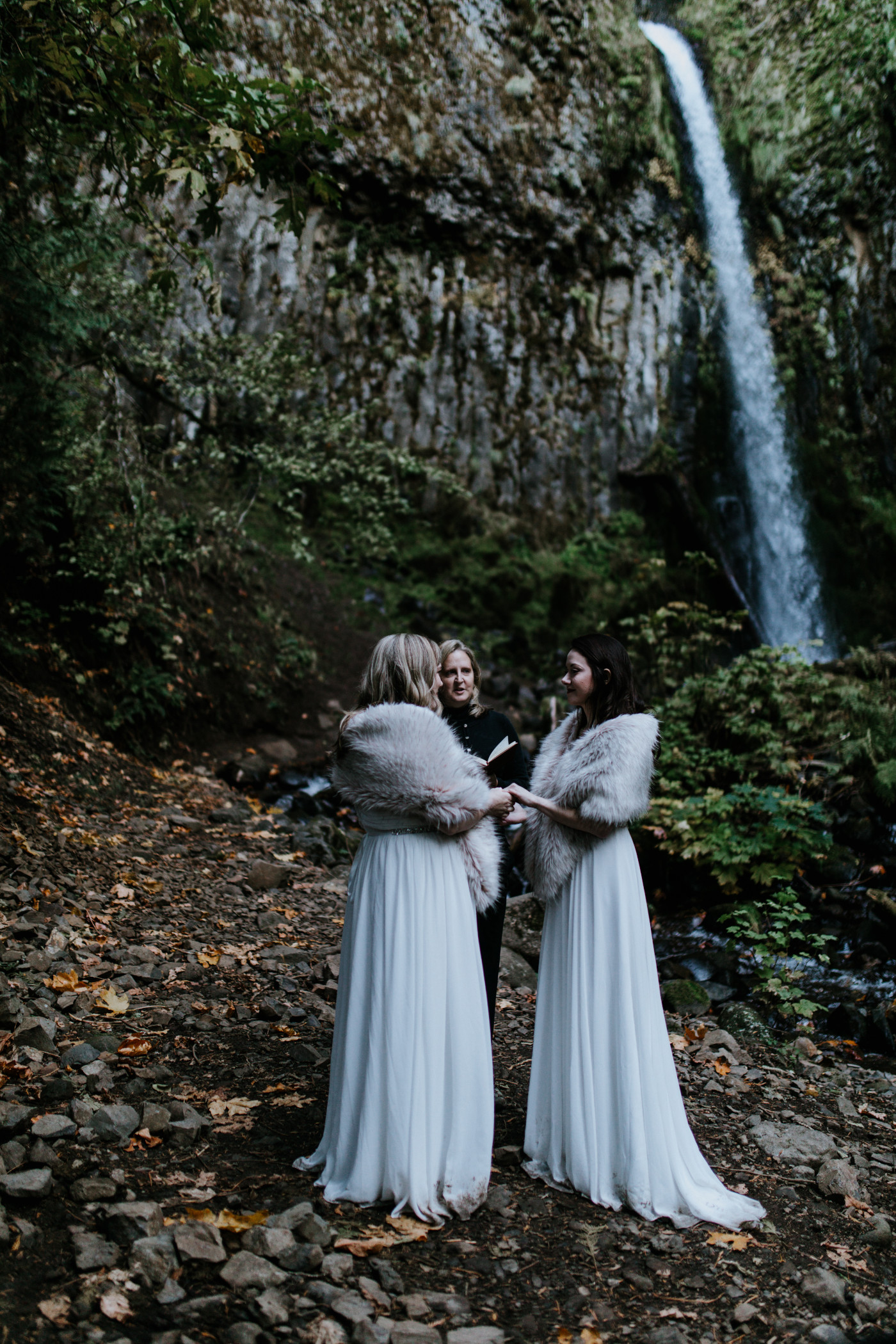Hayley and Tiffany during their elopement with a view of the waterfall in the background. Elopement photography at the Columbia River Gorge by Sienna Plus Josh.
