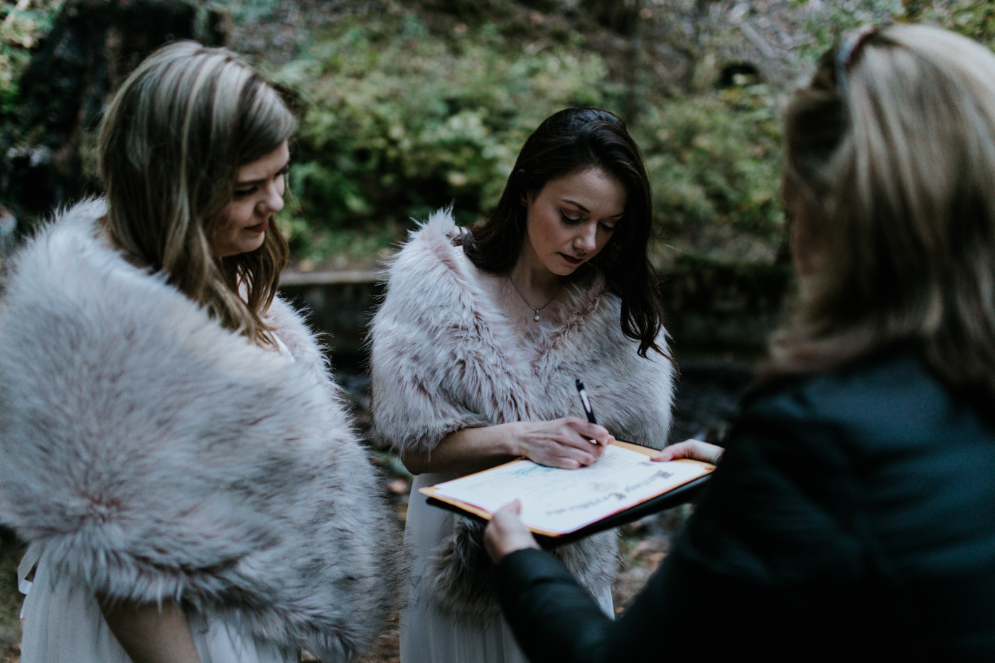 Tiffany signs the marriage license. Elopement photography at the Columbia River Gorge by Sienna Plus Josh.