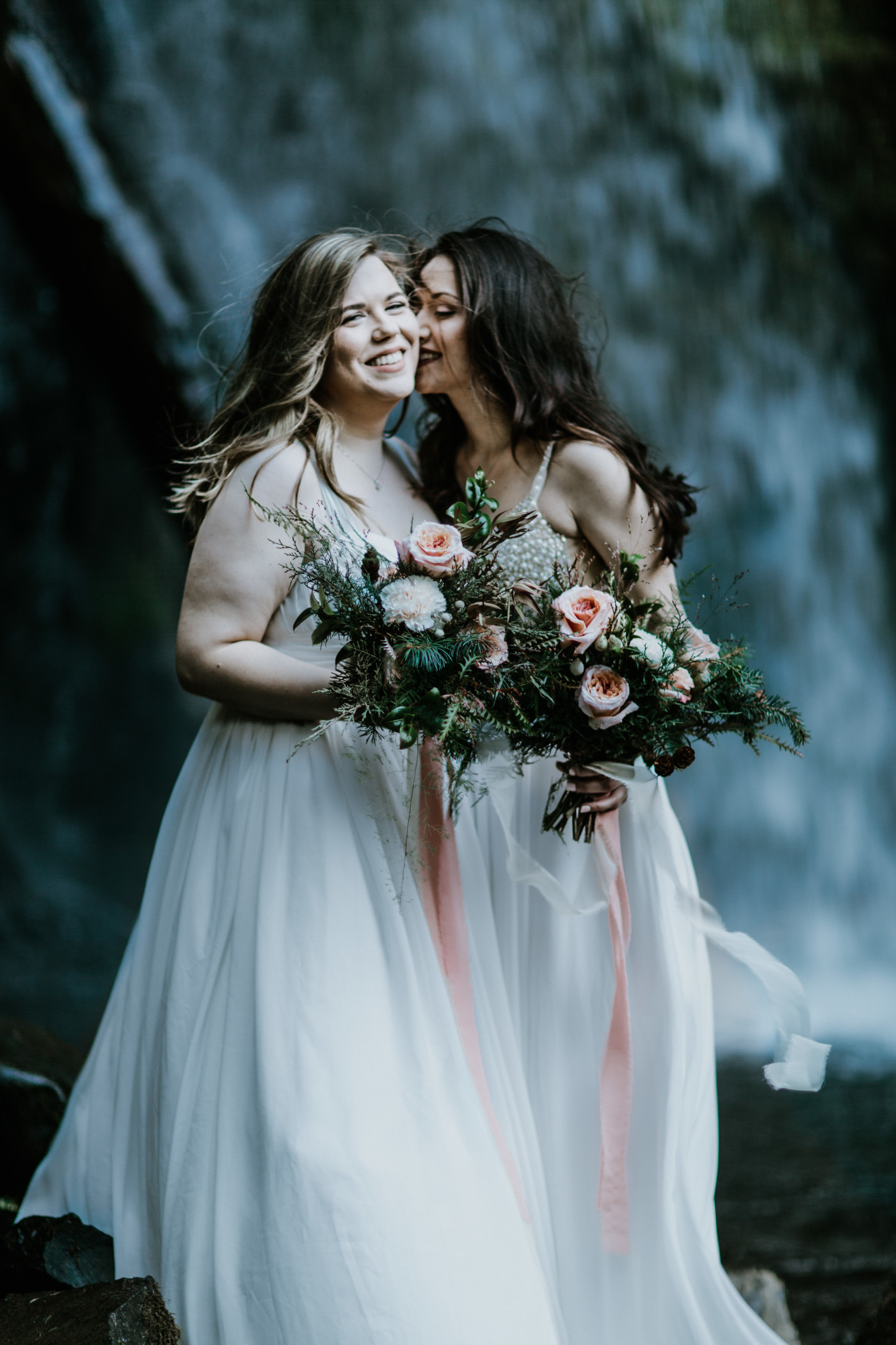 Hayley and Tiffany showing off their flowers. Elopement photography at the Columbia River Gorge by Sienna Plus Josh.