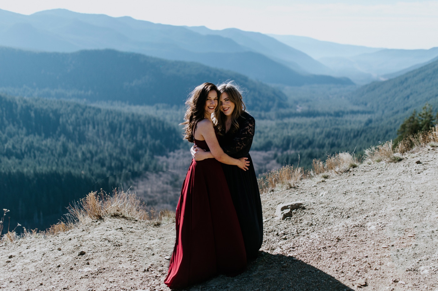 Tiffany and Hayley stand in the wind. Elopement photography at the Columbia River Gorge by Sienna Plus Josh.