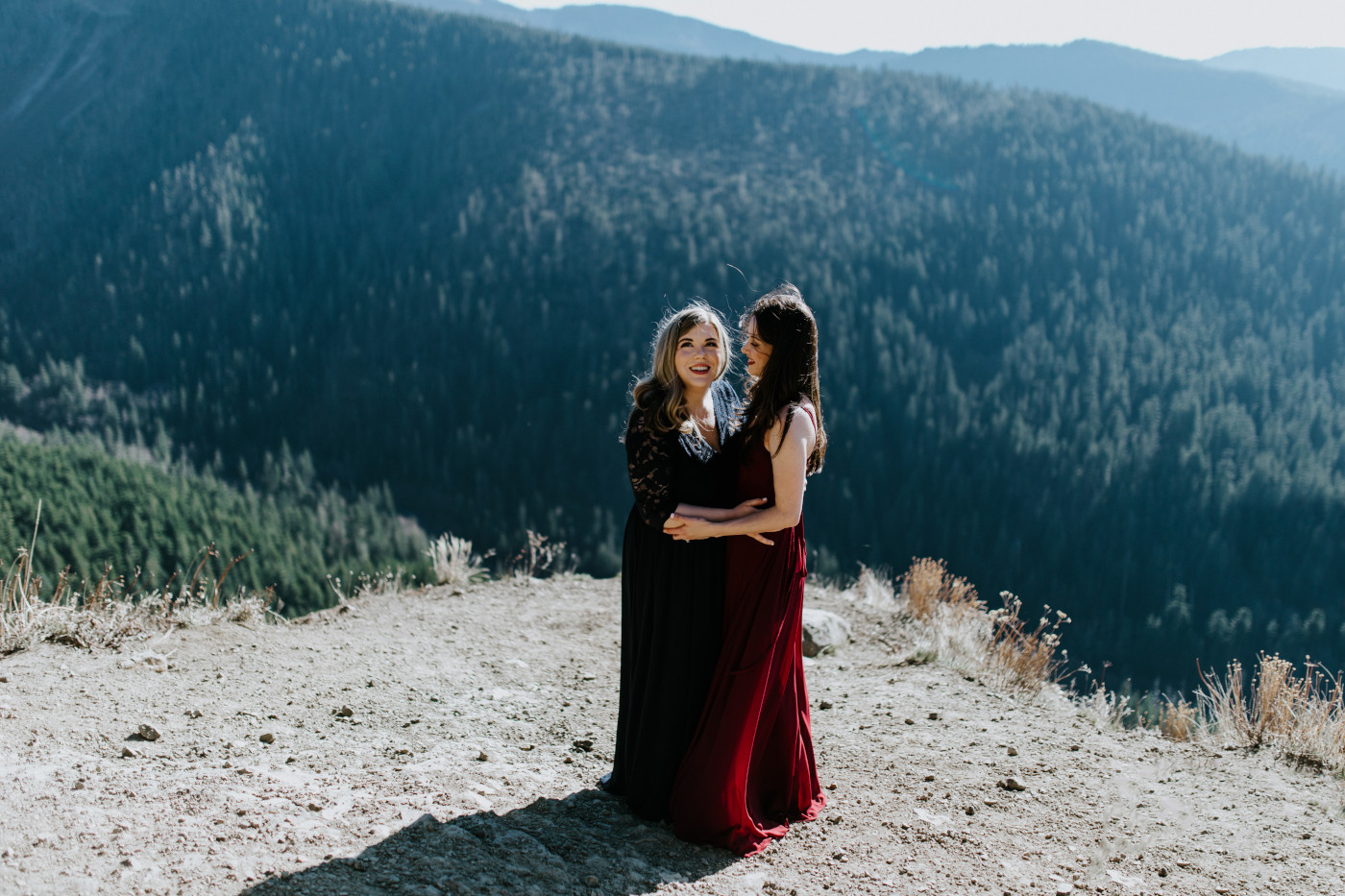 Tiffany and Hayley stand near a cliff in the Mt Hood area. Elopement photography at the Columbia River Gorge by Sienna Plus Josh.