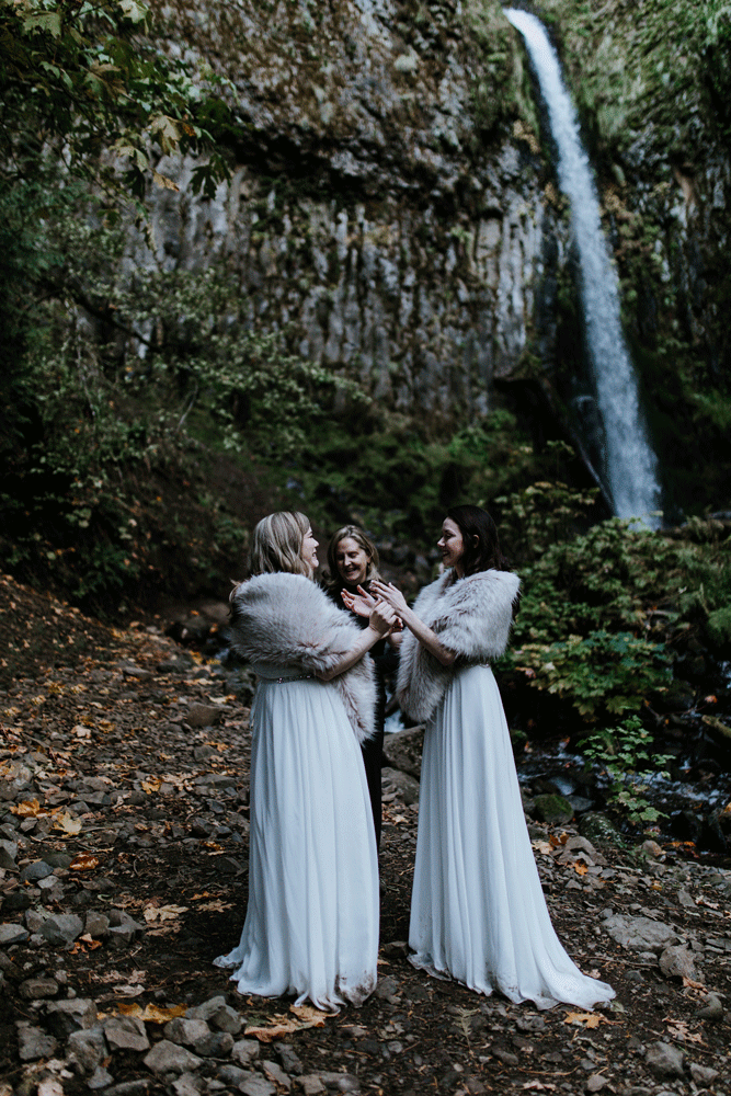An animated gif of Hayley and Tiffany kissing during their elopement ceremony with a view of the waterfall in the background. Elopement photography at the Columbia River Gorge by Sienna Plus Josh.