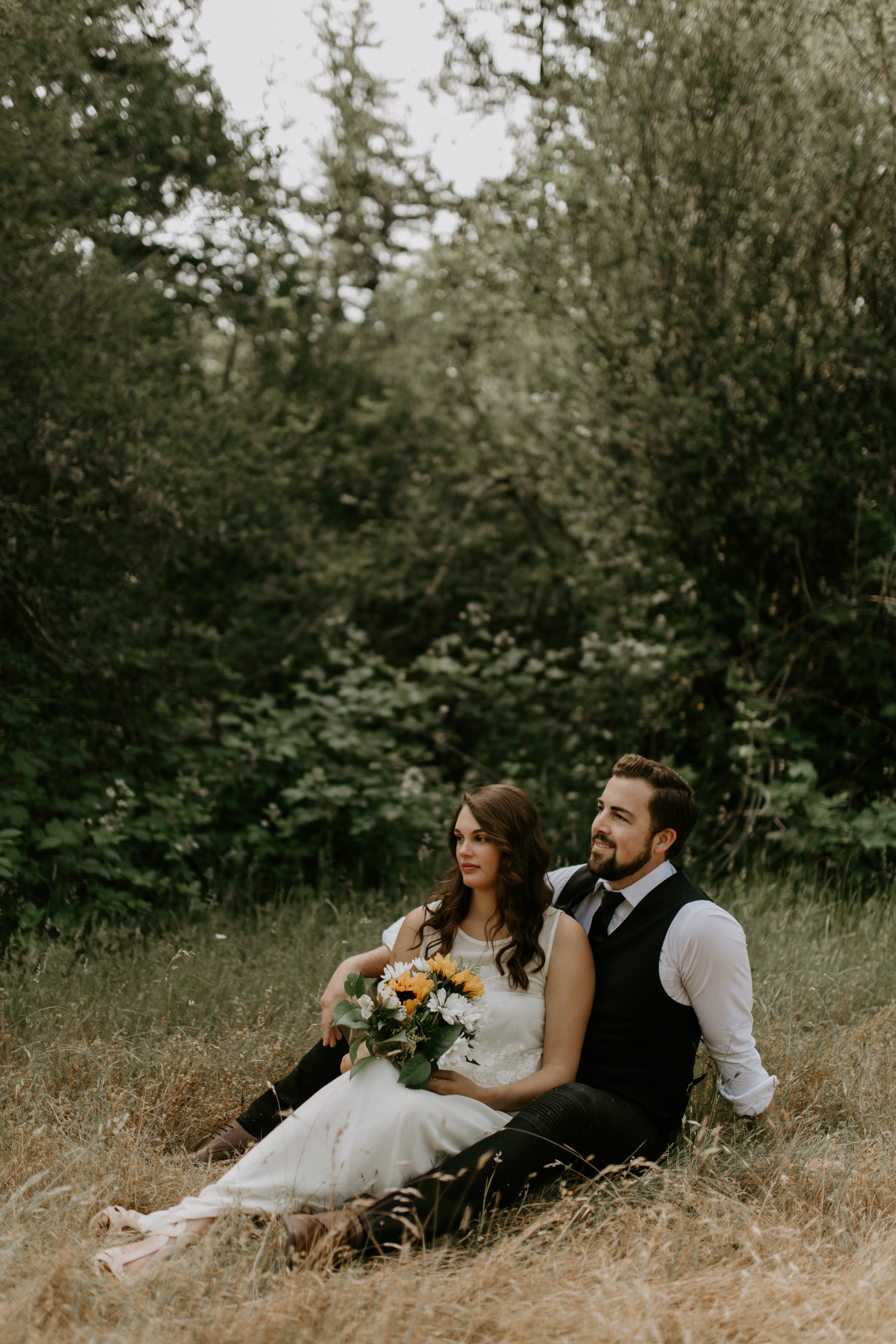Emily sits on Josh's lap at Bridal Veil Falls in Oregon. Elopement photography in Portland Oregon by Sienna Plus Josh.