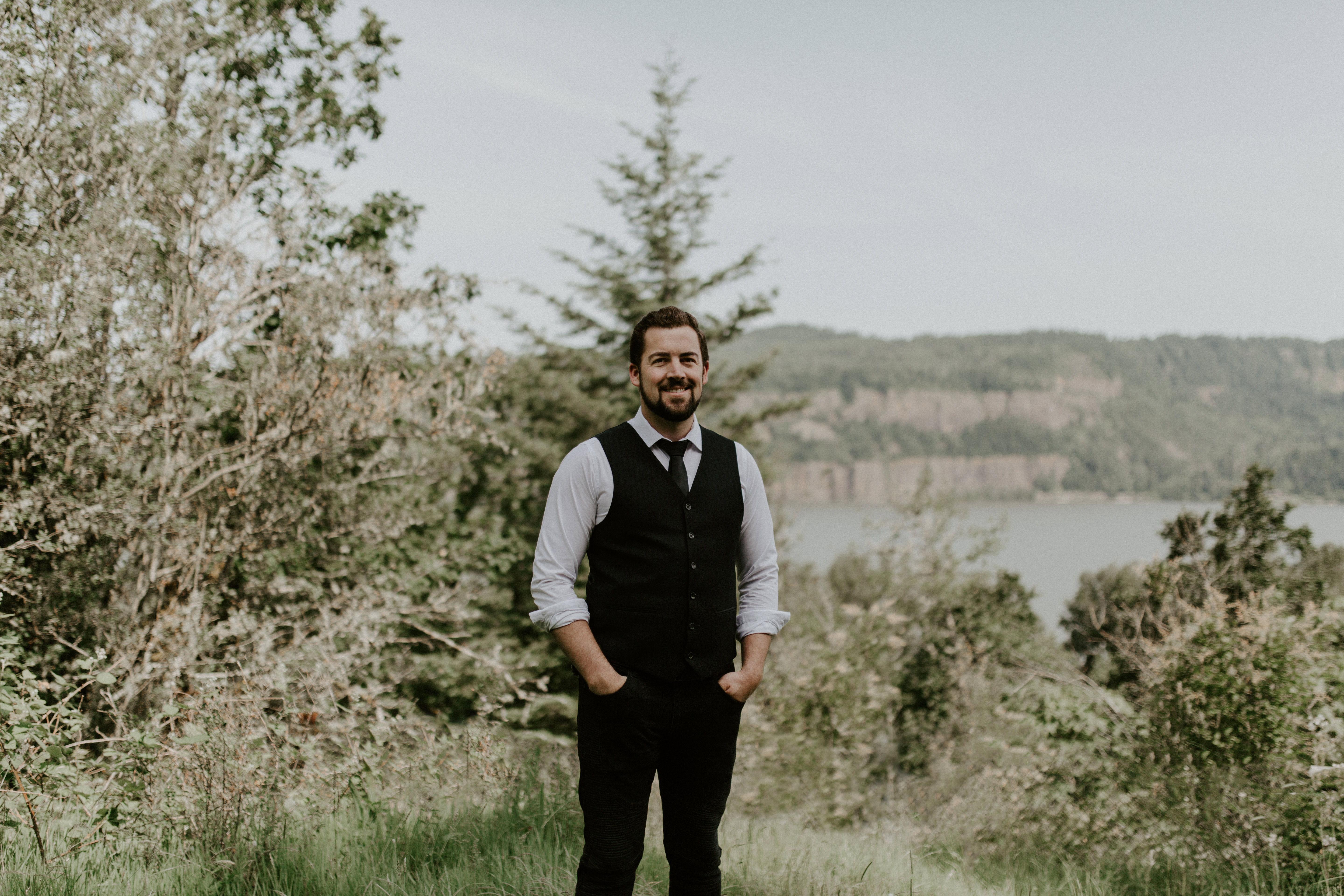 Josh stands at Bridal Veil Falls in Oregon. Elopement photography in Portland Oregon by Sienna Plus Josh.