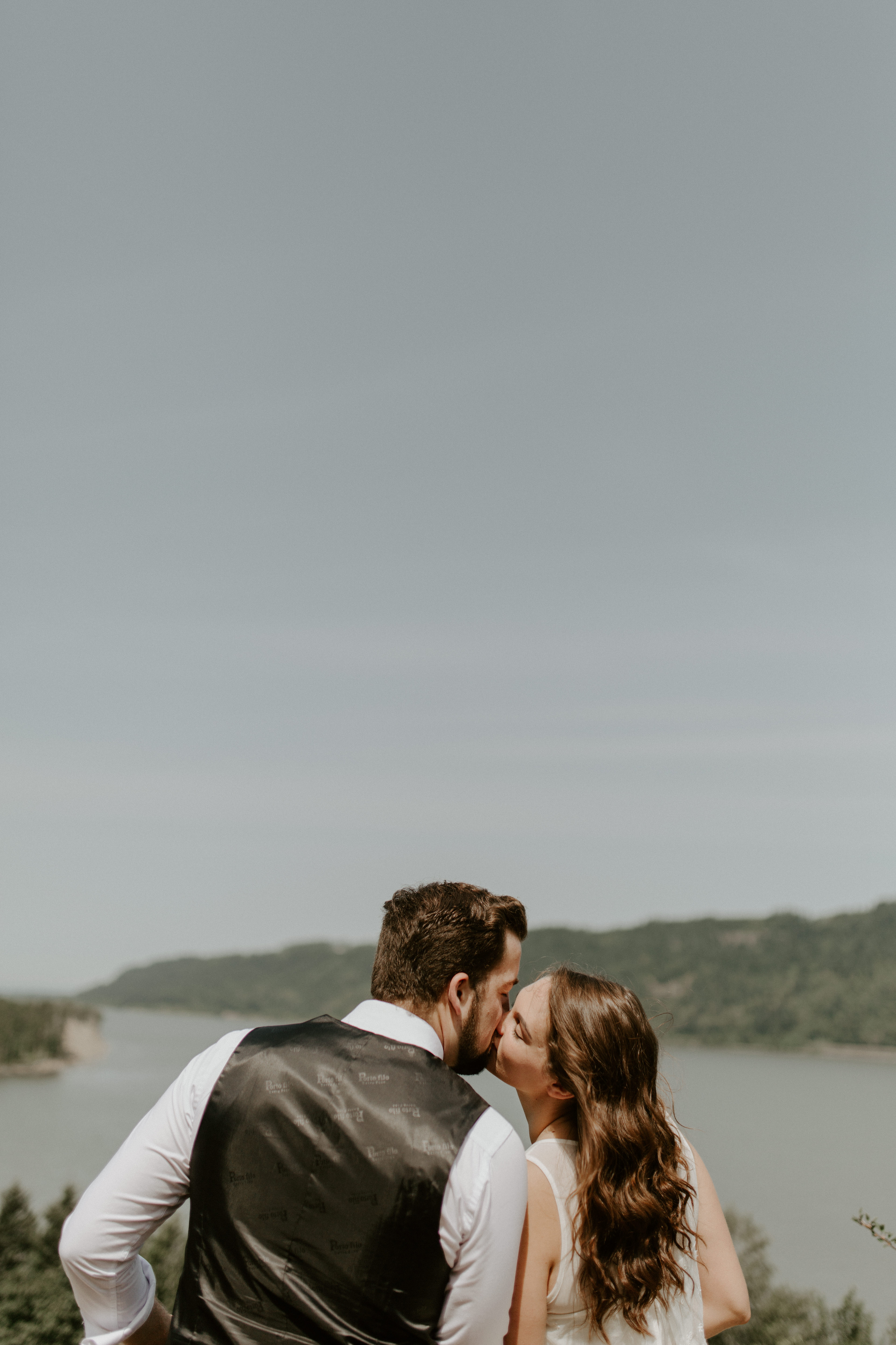 Emily and Josh kiss at Bridal Veil Falls, Oregon during their Oregon elopement. Elopement photography in Portland Oregon by Sienna Plus Josh.