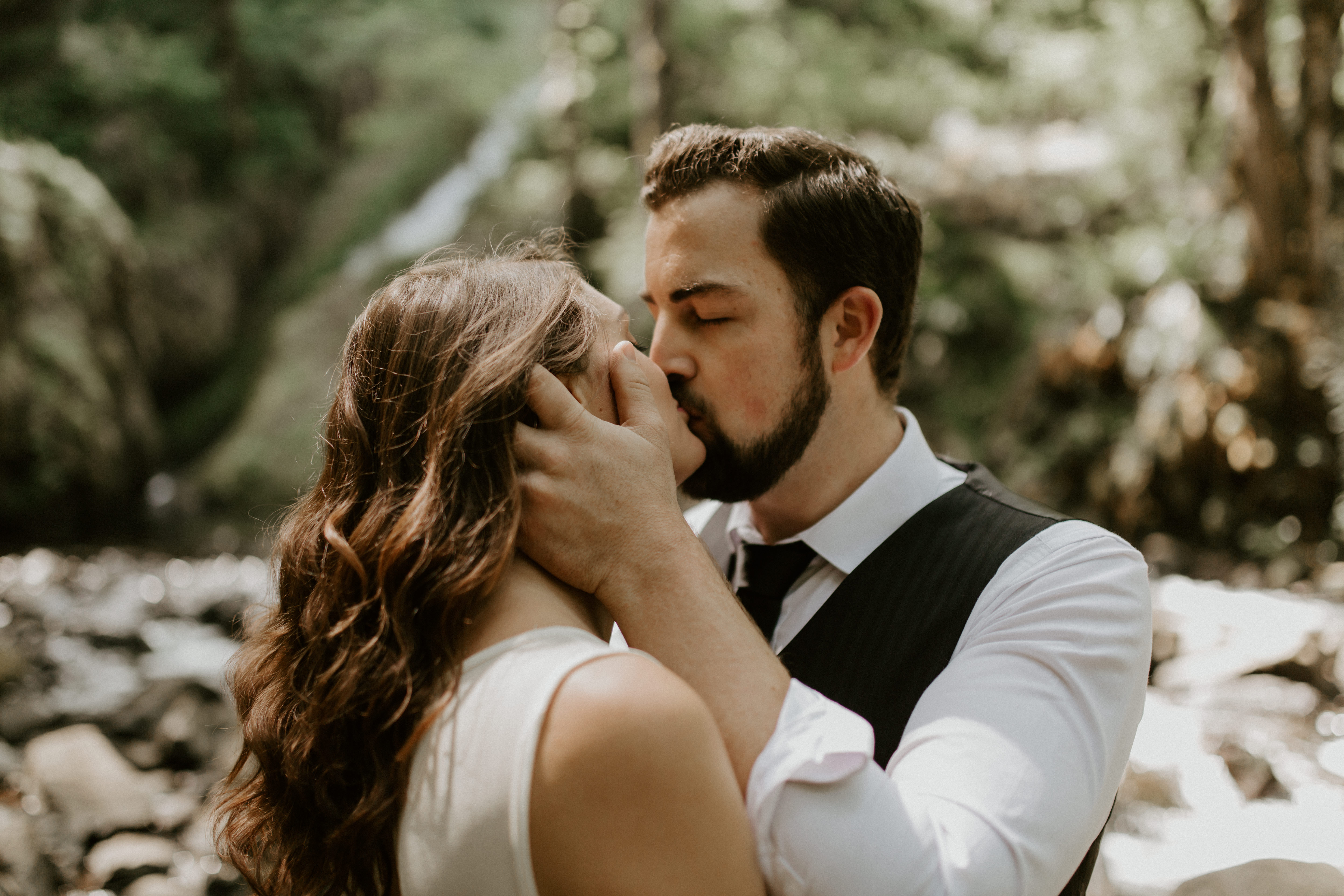 Emily and Josh kiss at Bridal Veil Falls, Oregon during their elopement. Elopement photography in Portland Oregon by Sienna Plus Josh.