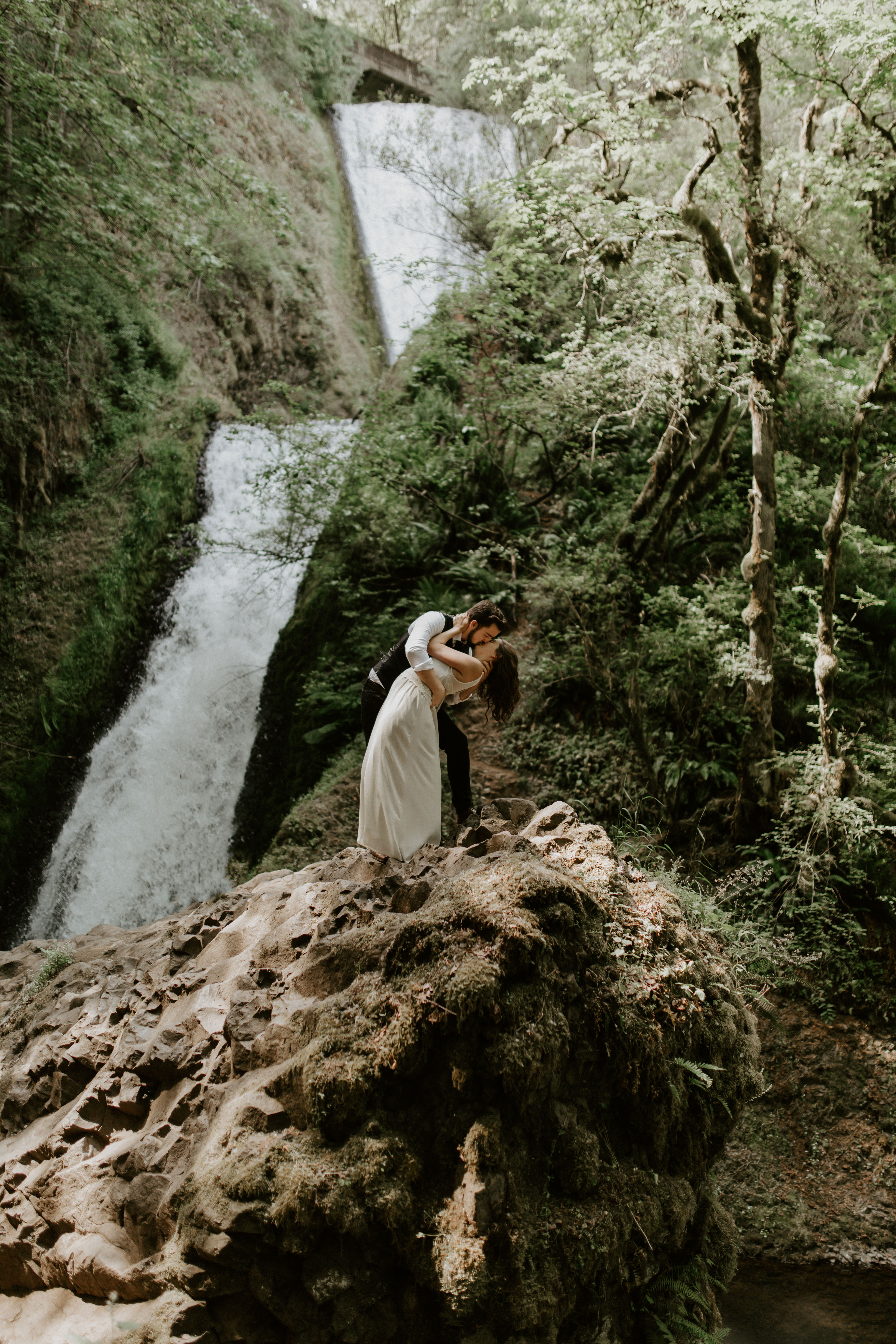 Josh dips Emily near a waterfall at Bridal Veil Falls, Oregon. Elopement photography in Portland Oregon by Sienna Plus Josh.