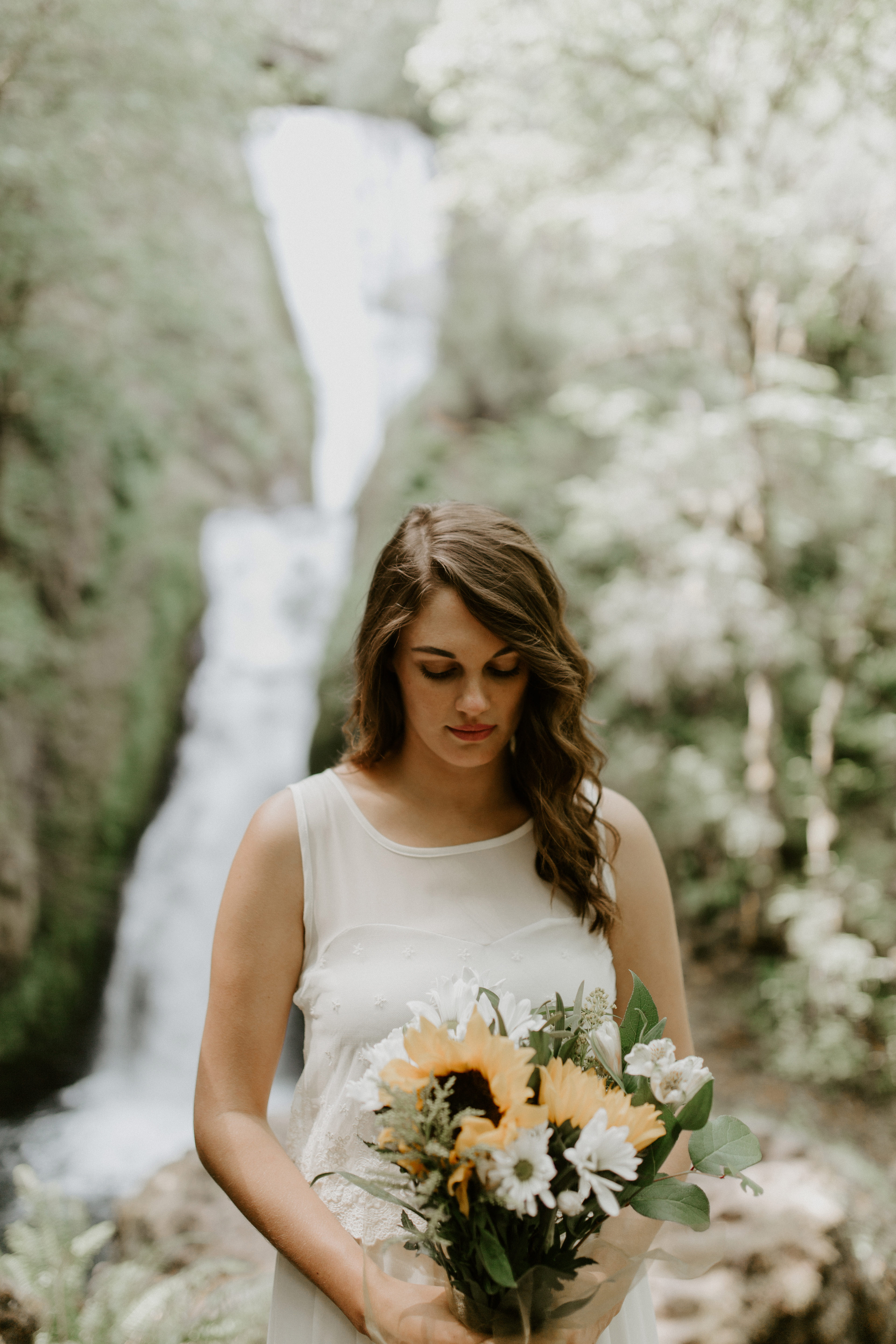 Emily holds her bouquet at the Columbia River Gorge in Oregon. Elopement photography in Portland Oregon by Sienna Plus Josh.