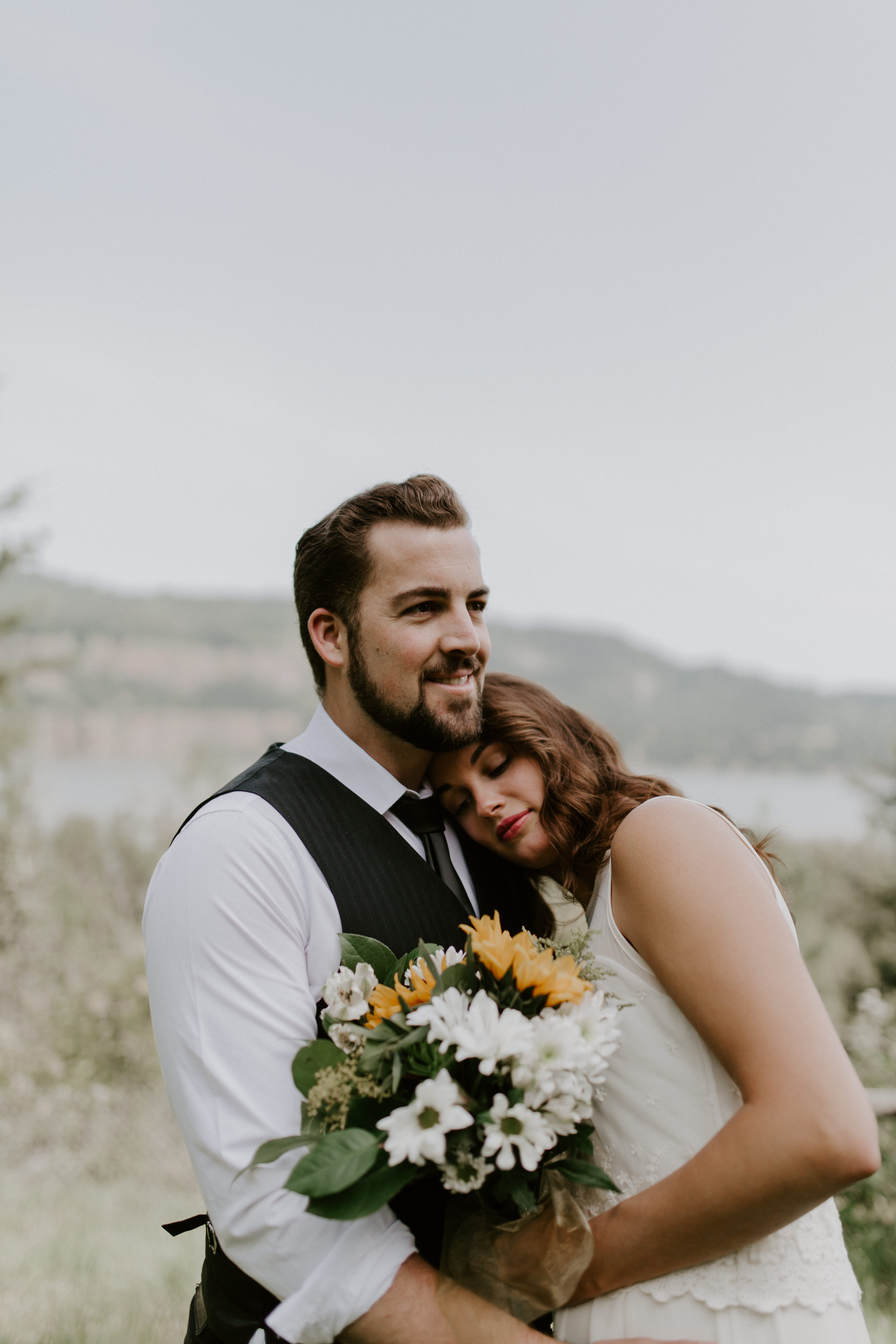 Emily and Josh hug at the Columbia River Gorge in Oregon. Elopement photography in Portland Oregon by Sienna Plus Josh.