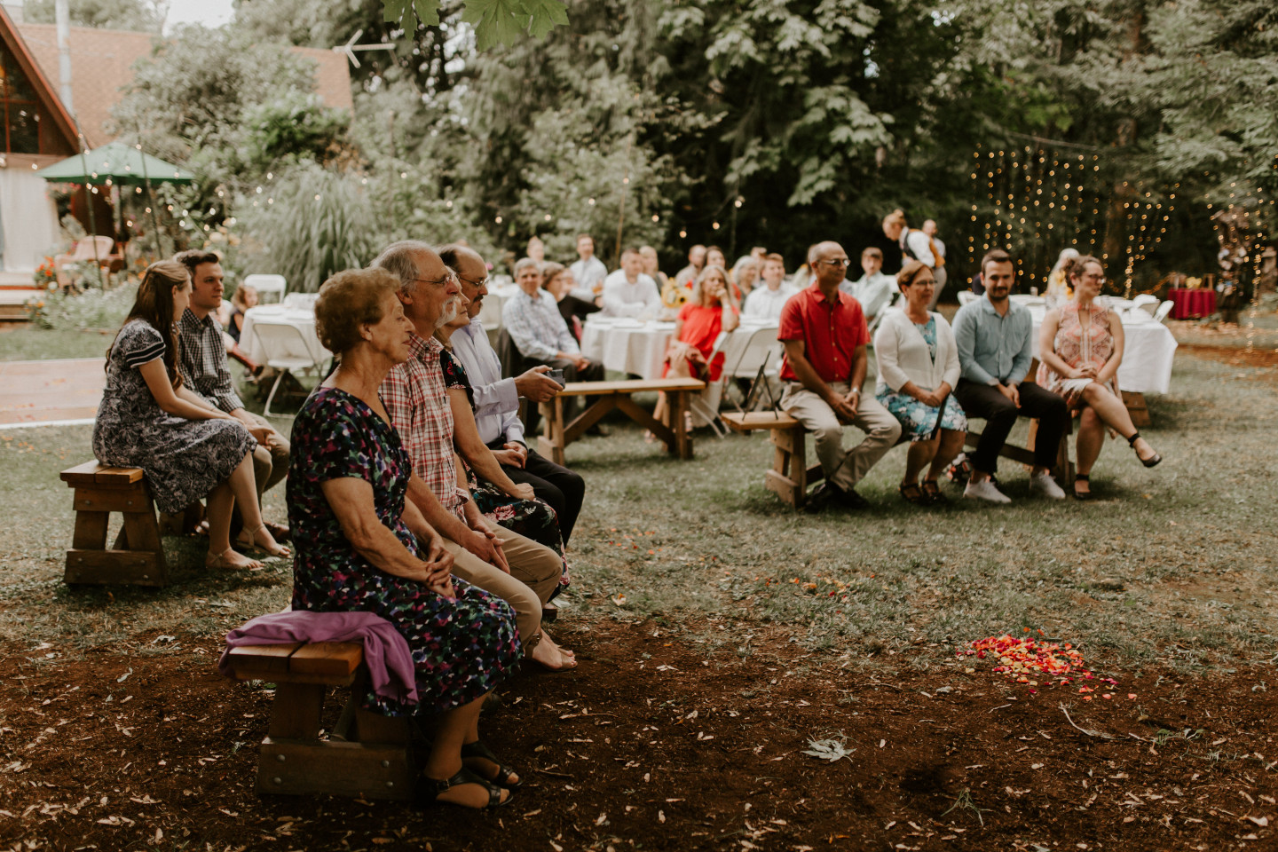 Guests look on at the wedding in Corvallis, Oregon. Intimate wedding photography in Corvallis Oregon by Sienna Plus Josh.