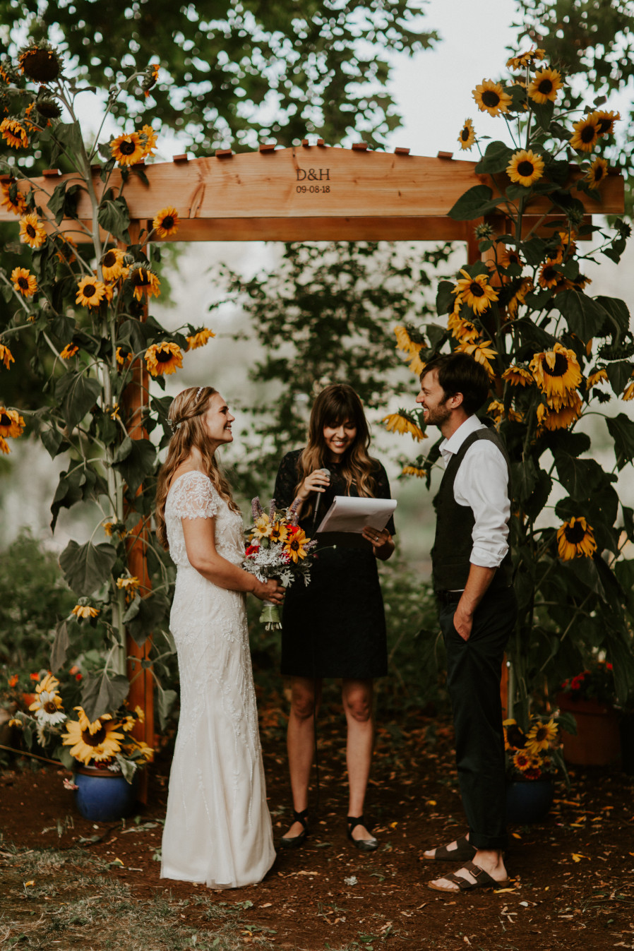 The officiant reads to Hannah and Dan in Corvallis, Oregon. Intimate wedding photography in Corvallis Oregon by Sienna Plus Josh.