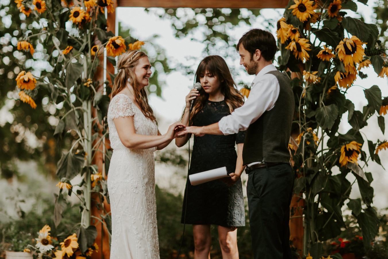 Hannah places a ring on Dan's finger in Corvallis, Oregon. Intimate wedding photography in Corvallis Oregon by Sienna Plus Josh.