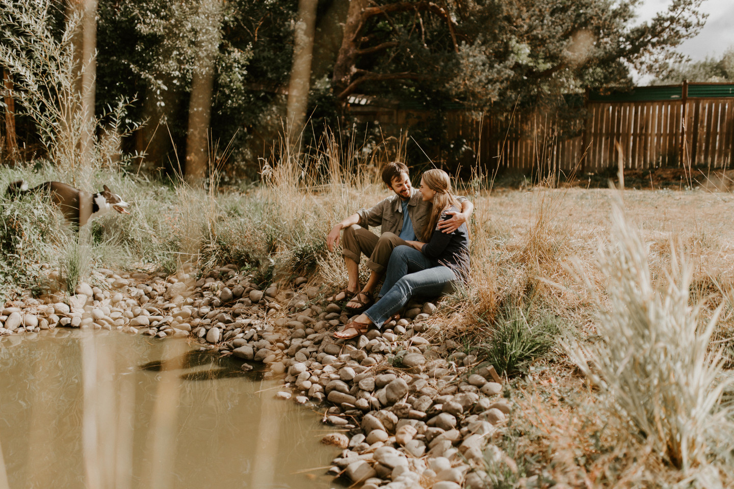Dan and Hannah sit next to a pond in Corvallis, Oregon. Intimate wedding photography in Corvallis Oregon by Sienna Plus Josh.