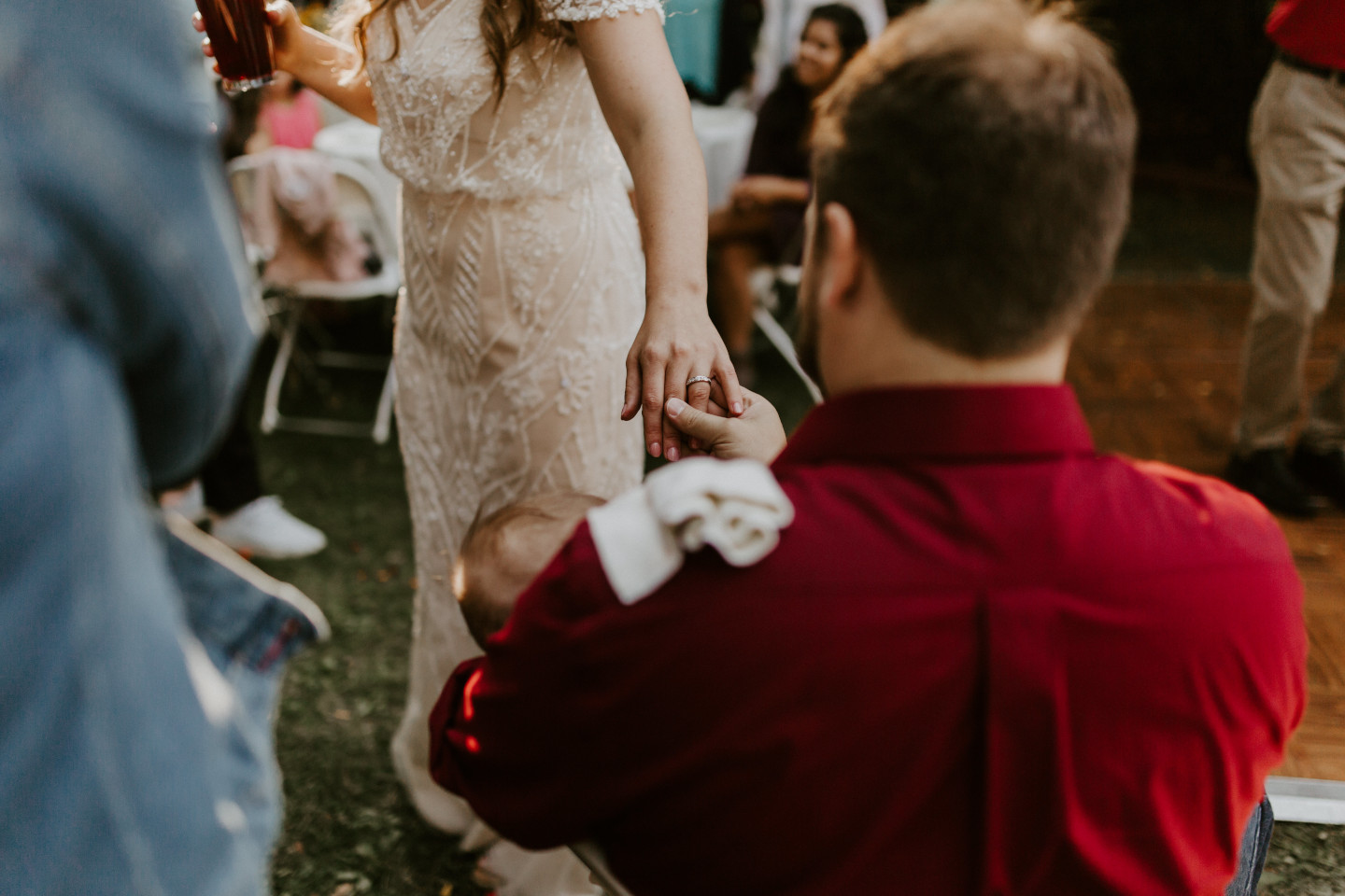 A guest admires Hannah's ring in Corvallis, Oregon. Intimate wedding photography in Corvallis Oregon by Sienna Plus Josh.