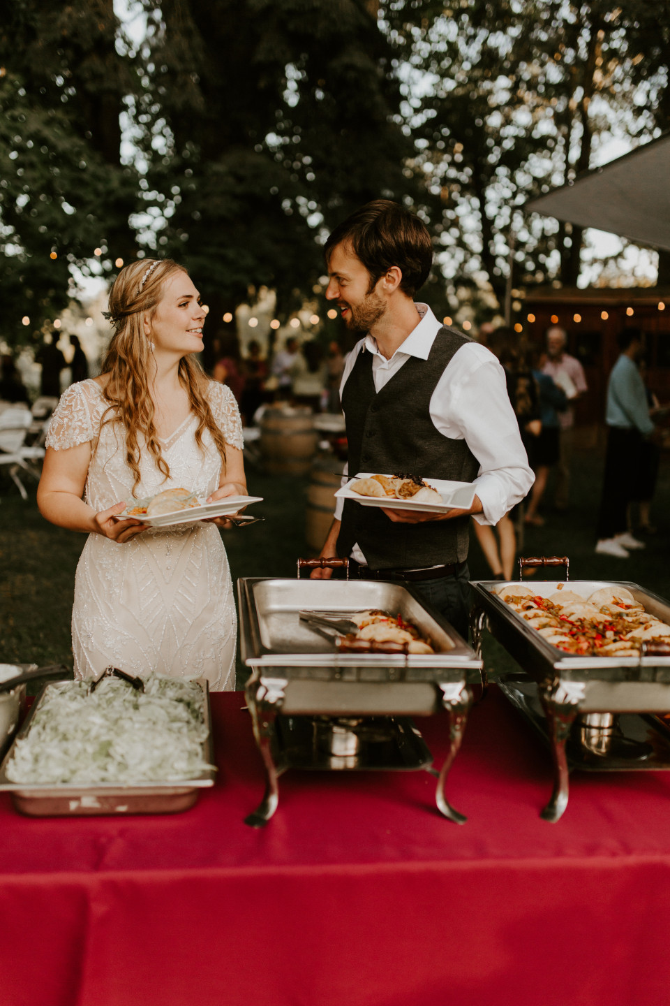 Hannah and Dan serving themselves food in Corvallis, Oregon. Intimate wedding photography in Corvallis Oregon by Sienna Plus Josh.