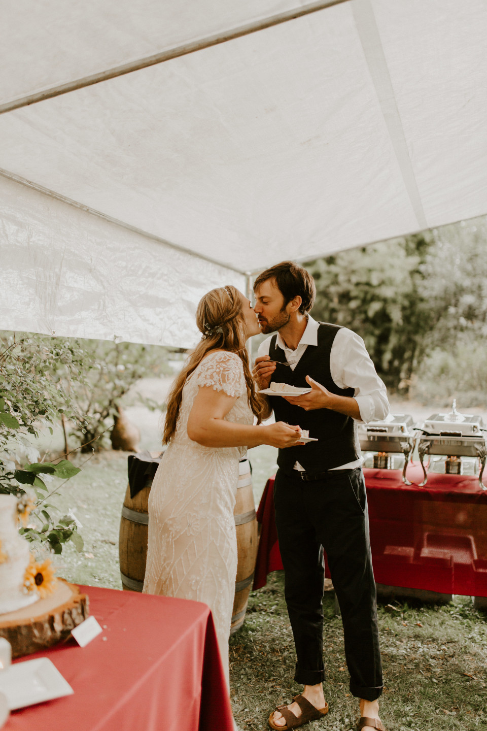 Hannah and Dan kiss after cutting the cake in Corvallis, Oregon. Intimate wedding photography in Corvallis Oregon by Sienna Plus Josh.