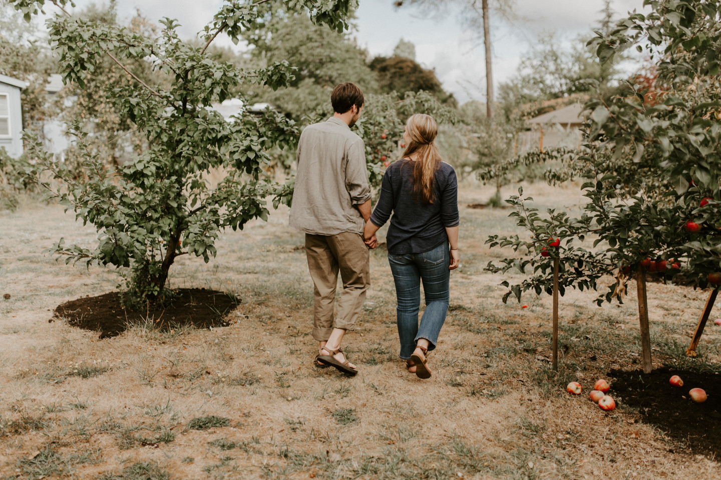 Dan and Hannah stroll through an apple orchard at their house in Corvallis Oregon. Intimate wedding photography in Corvallis Oregon by Sienna Plus Josh.