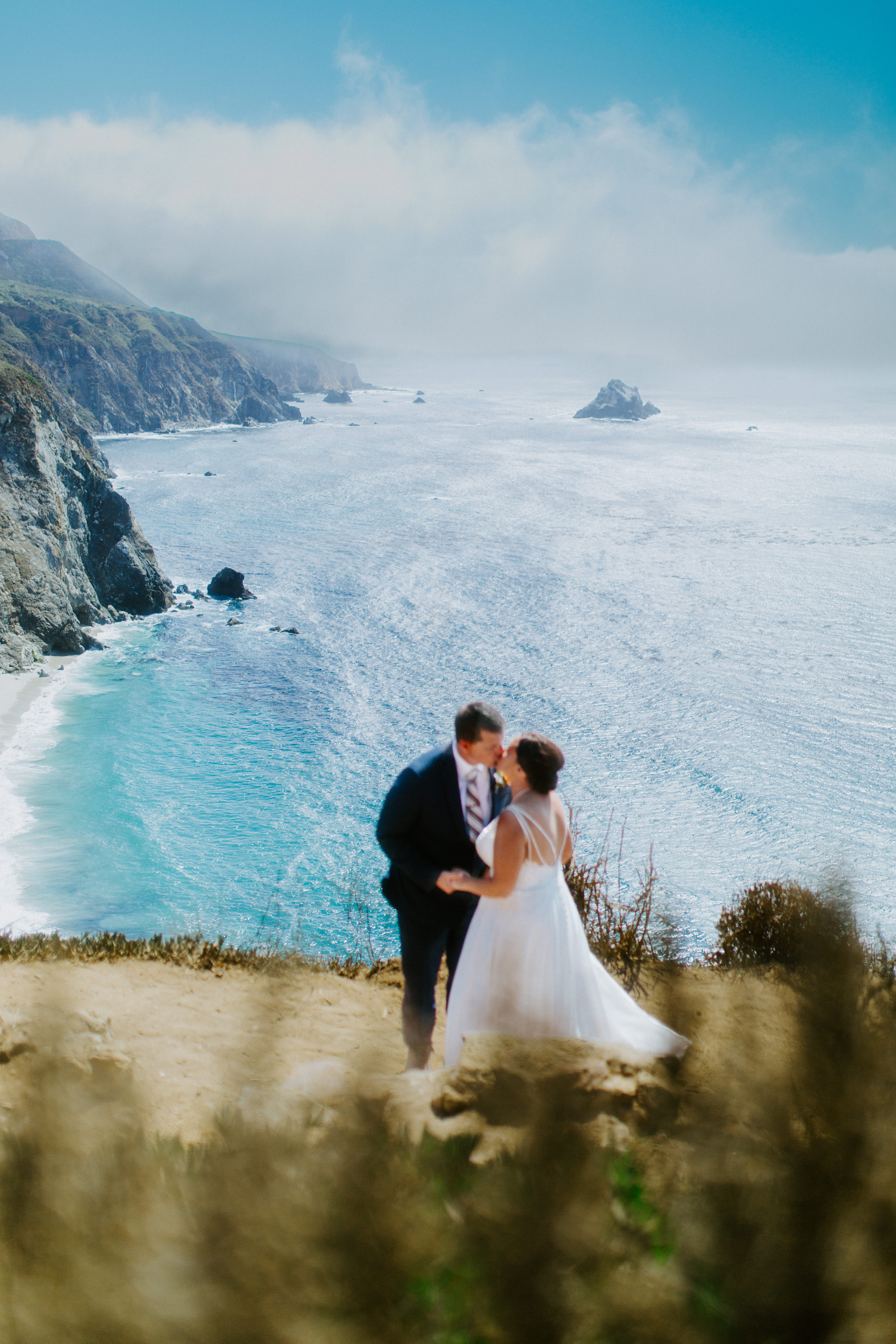 A couple stands at a view point along the Big Sur coast in Big Sur, California.