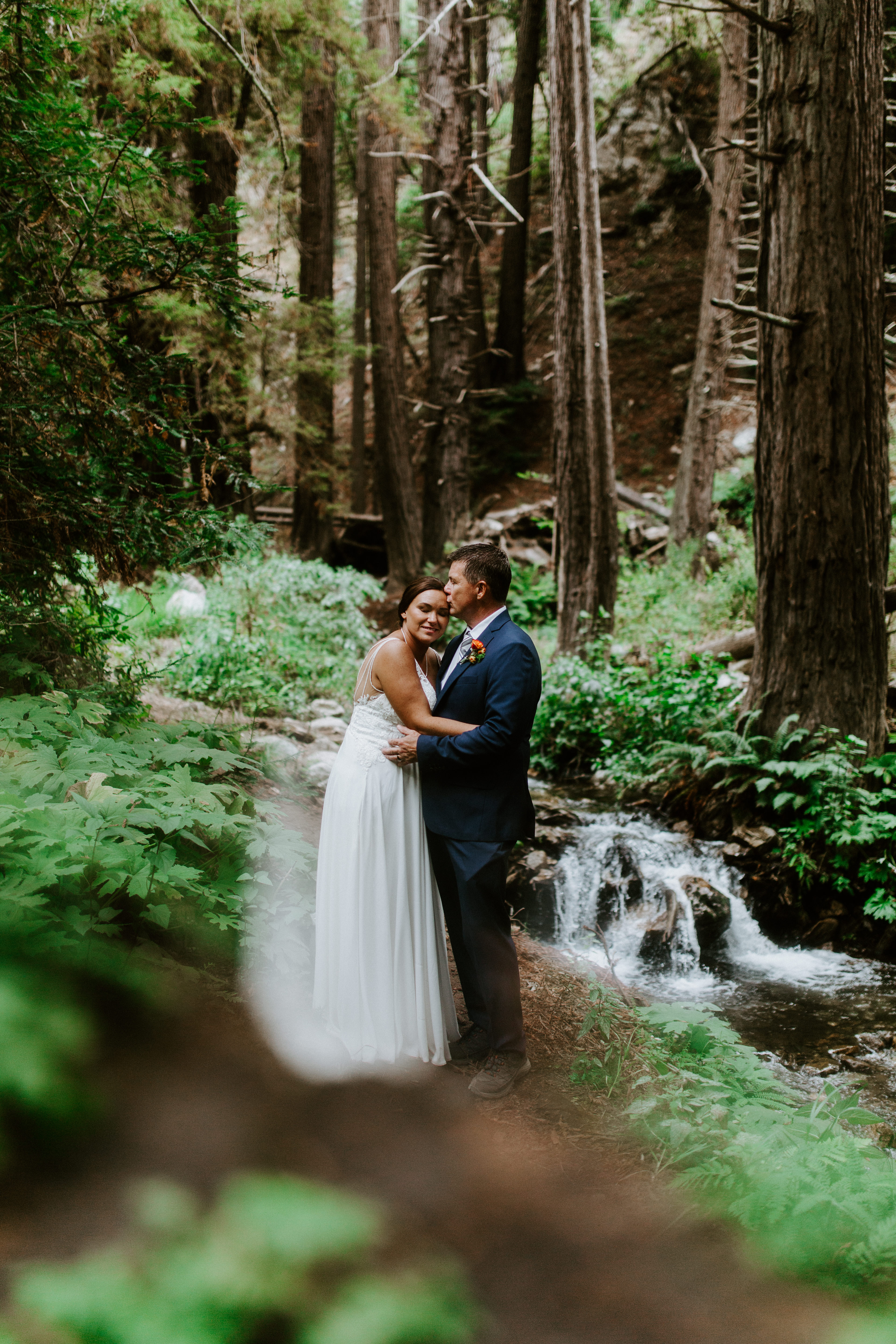 A couple hugs in the forest of Big Sur in Big Sur, California.