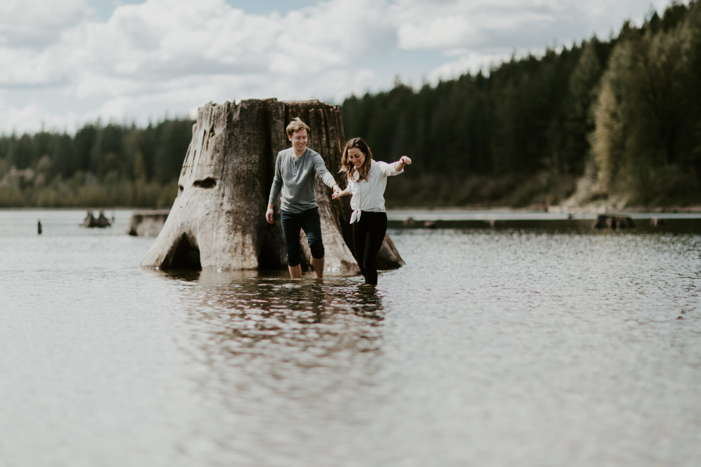 Adam and Janelle walk through the water at Rattlesnake Lake, WA. Adventure engagement session at Rattlesnake Lake, Washington by Sienna Plus Josh.
