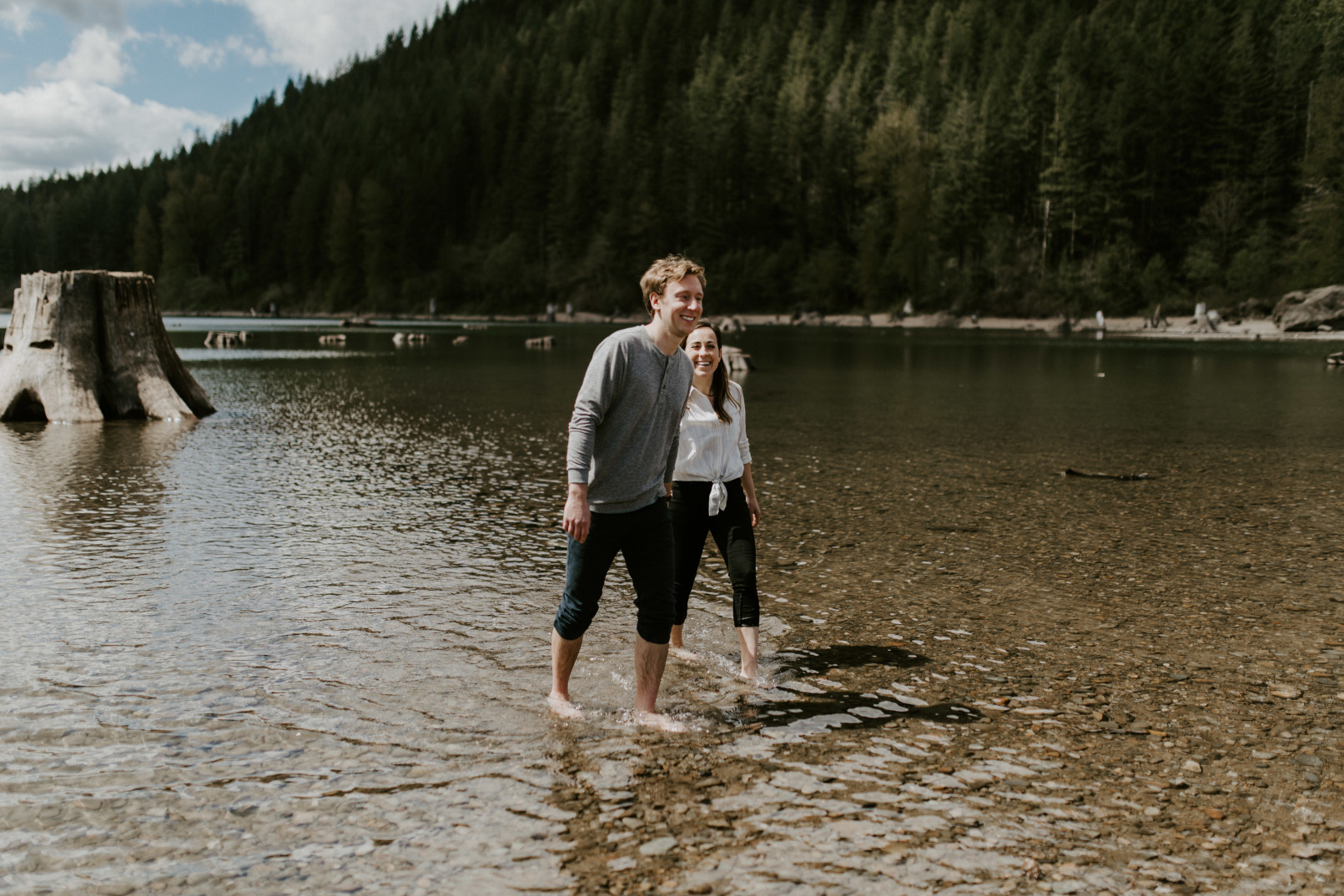 Adam holds Janelle's hand at Rattlesnake Lake. Adventure engagement session at Rattlesnake Lake, Washington by Sienna Plus Josh.
