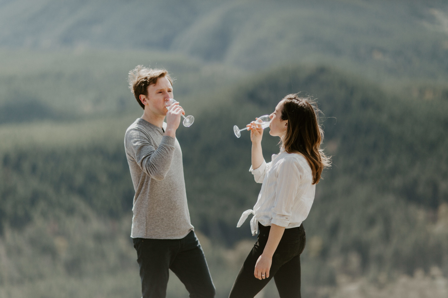 Adam and Janelle take a drink of champagne. Adventure engagement session at Rattlesnake Lake, Washington by Sienna Plus Josh.