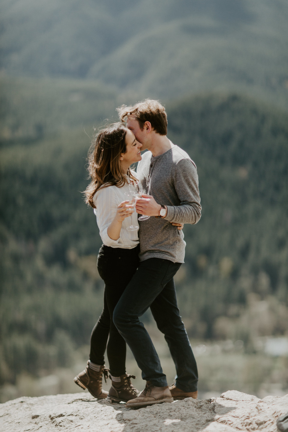 Janelle and Adam kiss in font of Rattlesnake Lake, WA. Adventure engagement session at Rattlesnake Lake, Washington by Sienna Plus Josh.