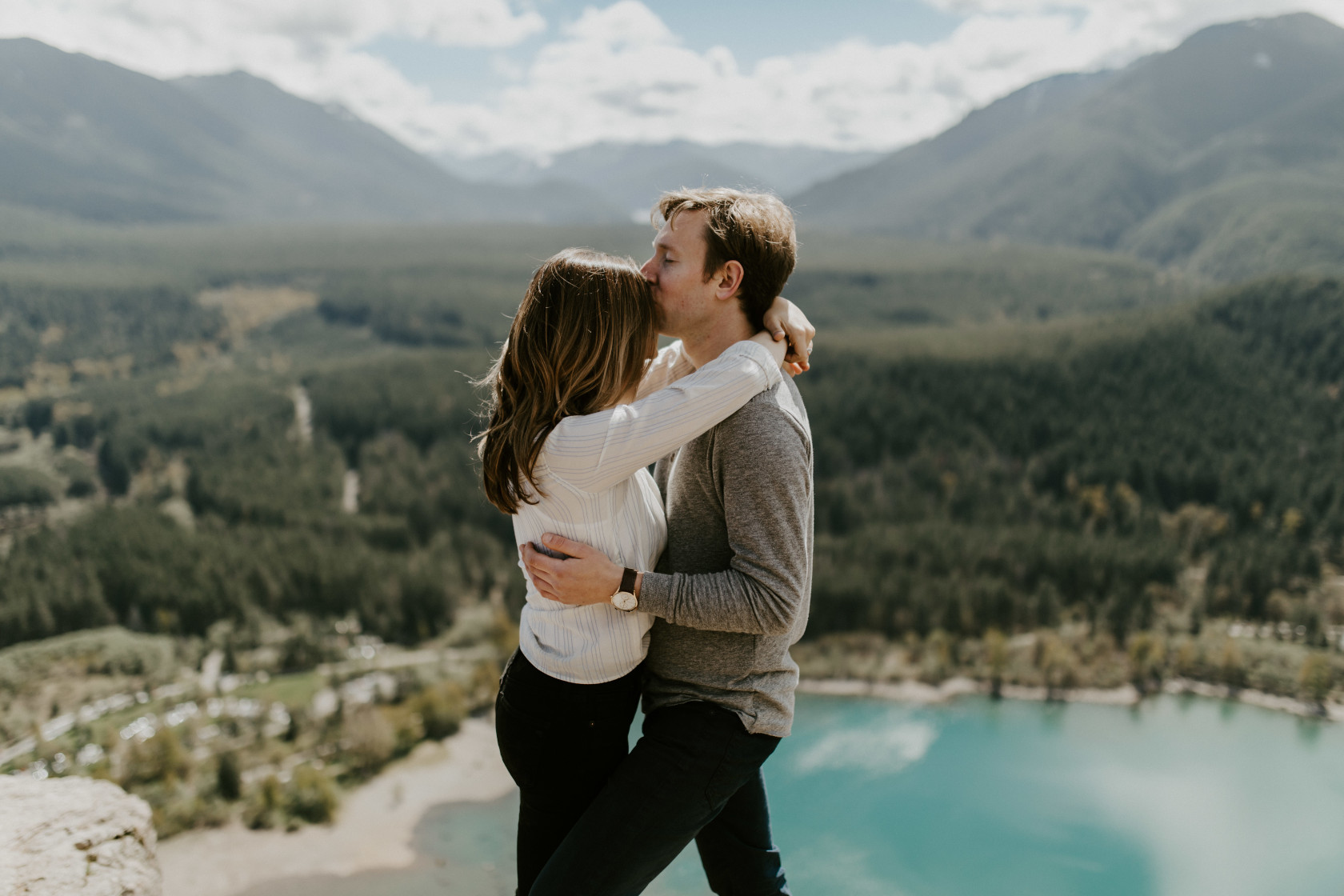 Adam kisses Janelle's forehead at Rattlesnake Lake. Adventure engagement session at Rattlesnake Lake, Washington by Sienna Plus Josh.
