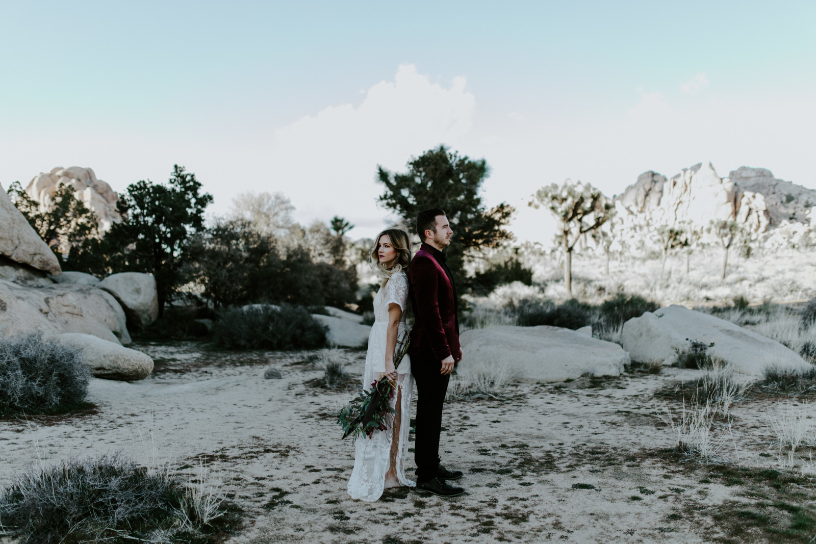 A bride and groom stand together after their elopement in Joshua Tree National Park.