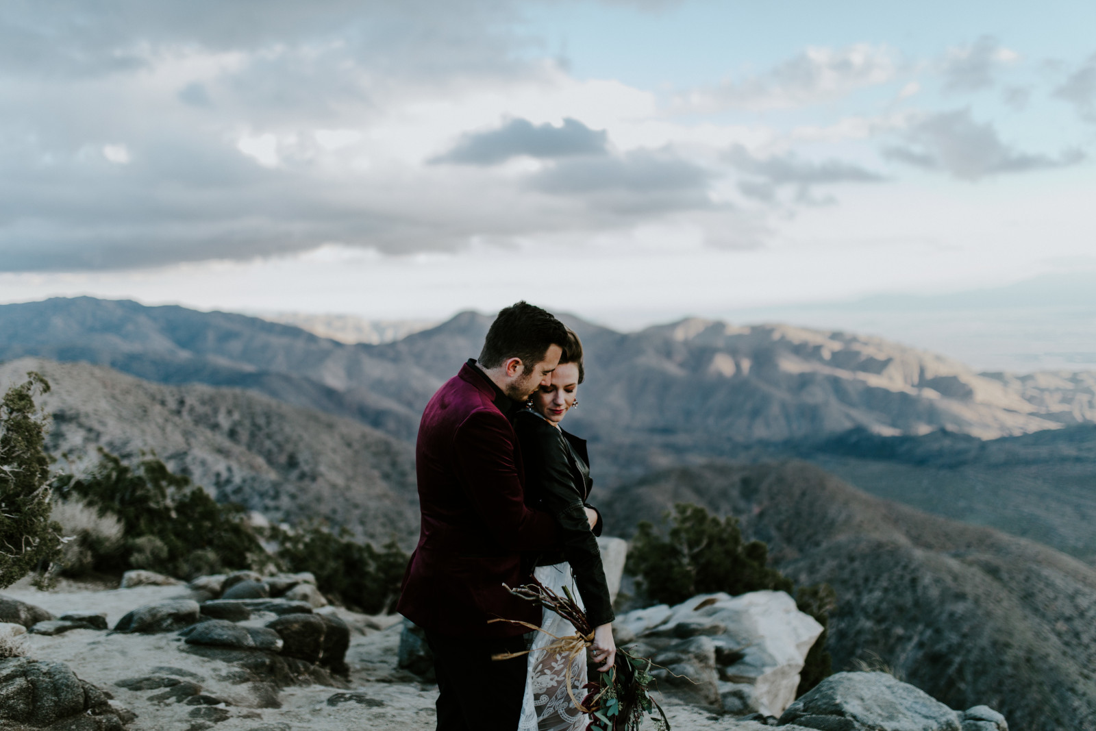 A couple stands at the viewpoint of Keys View in Joshua Tree National Park, California.