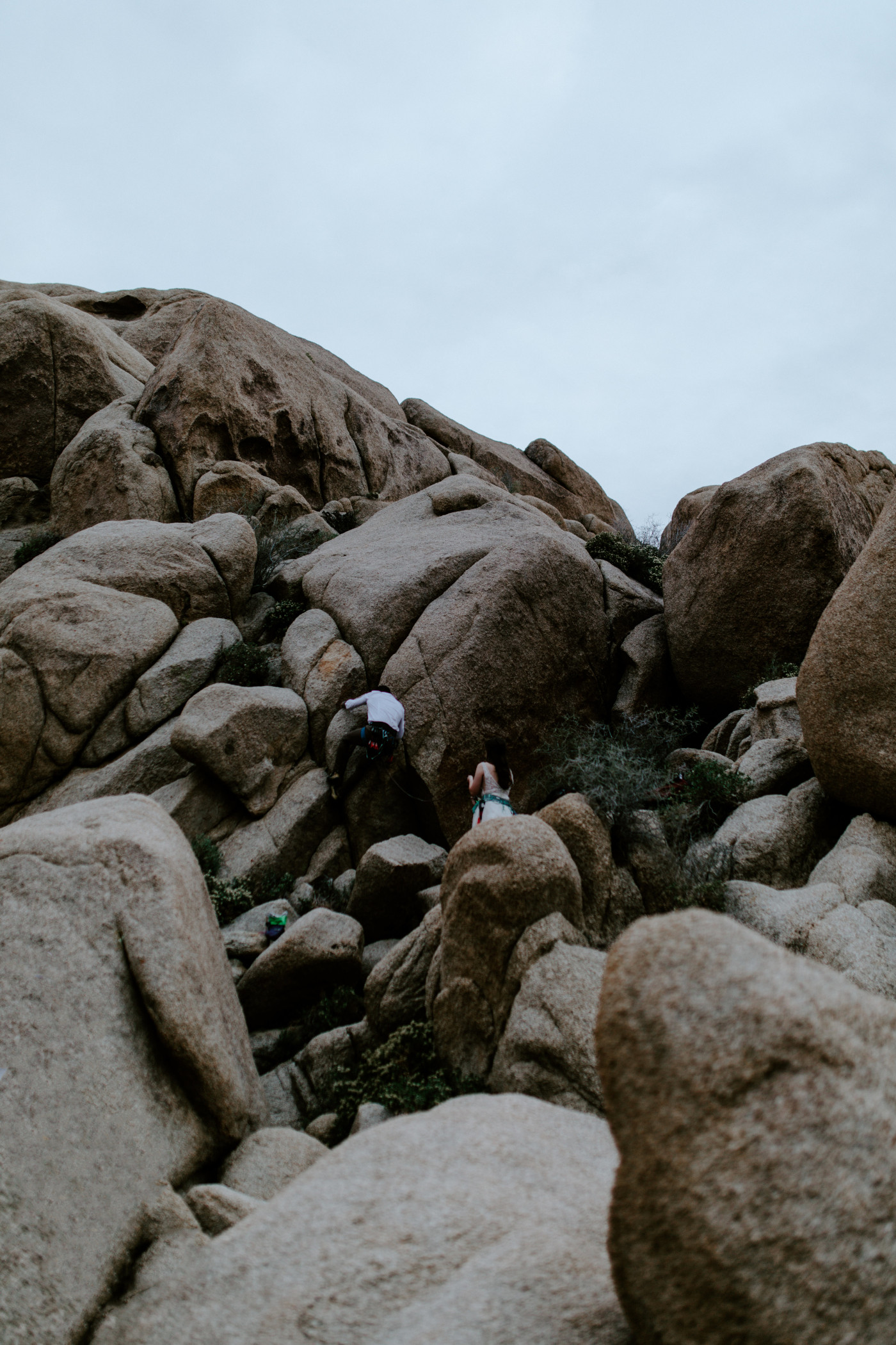 Shelby and Zack make their way up the boulders in Joshua Tree.