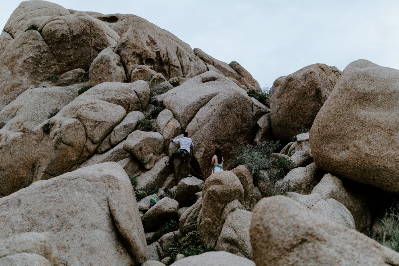 Shelby and Zack climb up the rocks of Joshua Tree.