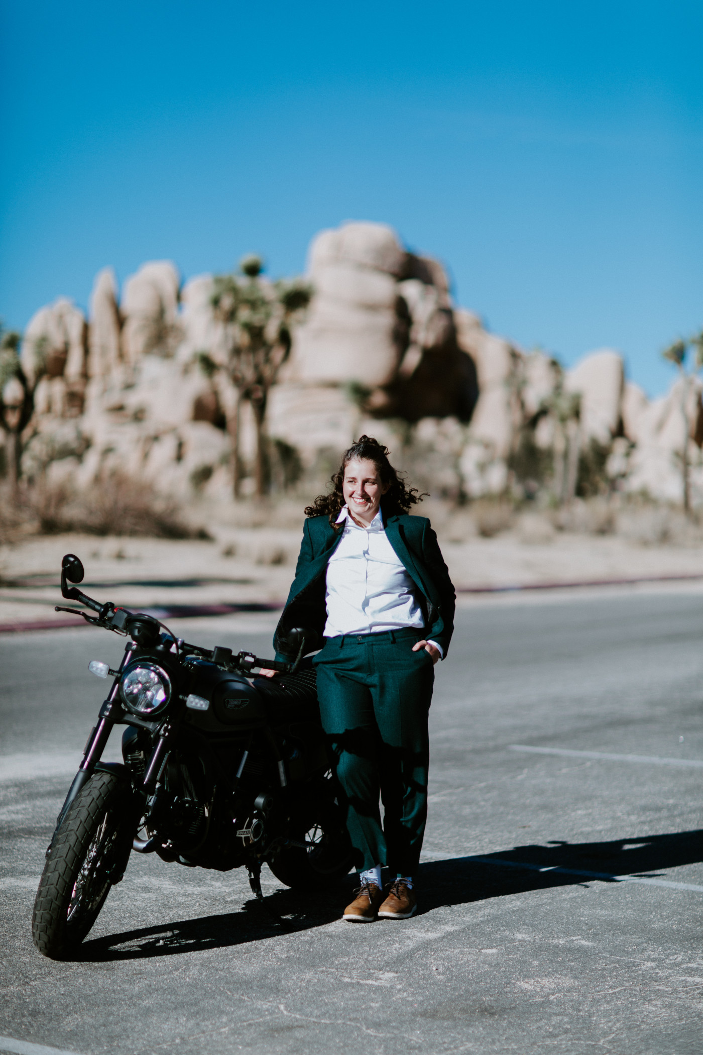 Standing near their motorcycle before the elopement.
