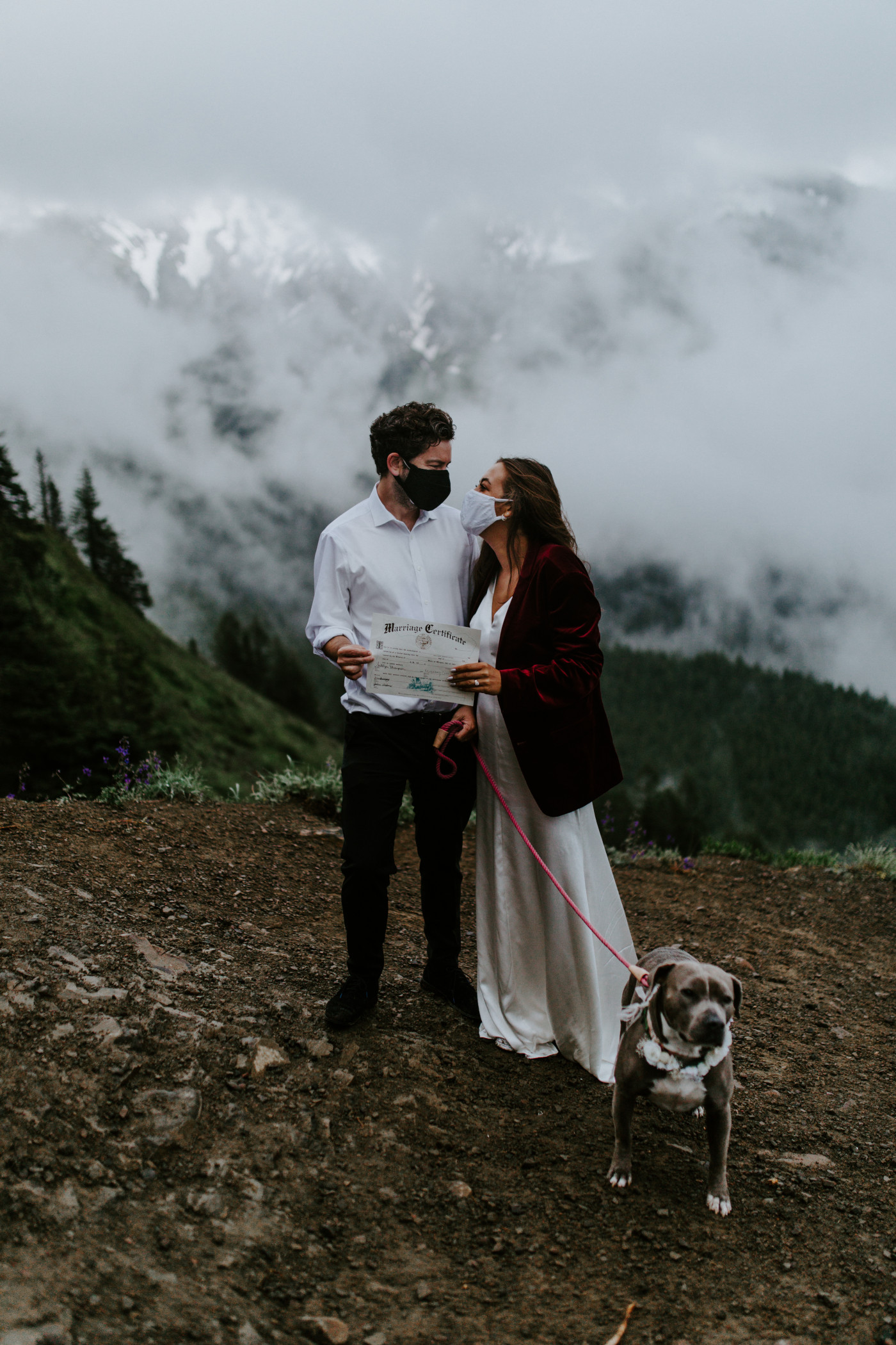 Katelyn and Murray stand in front of Mount Hood with their marriage license. Elopement wedding photography at Mount Hood by Sienna Plus Josh.