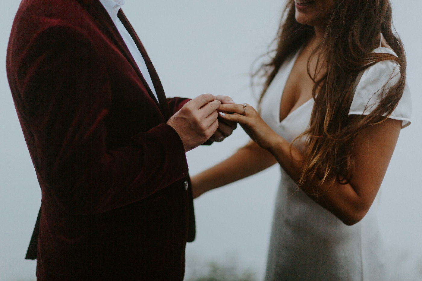 Murray goes to put a ring on Katelyn's finger. Elopement wedding photography at Mount Hood by Sienna Plus Josh.