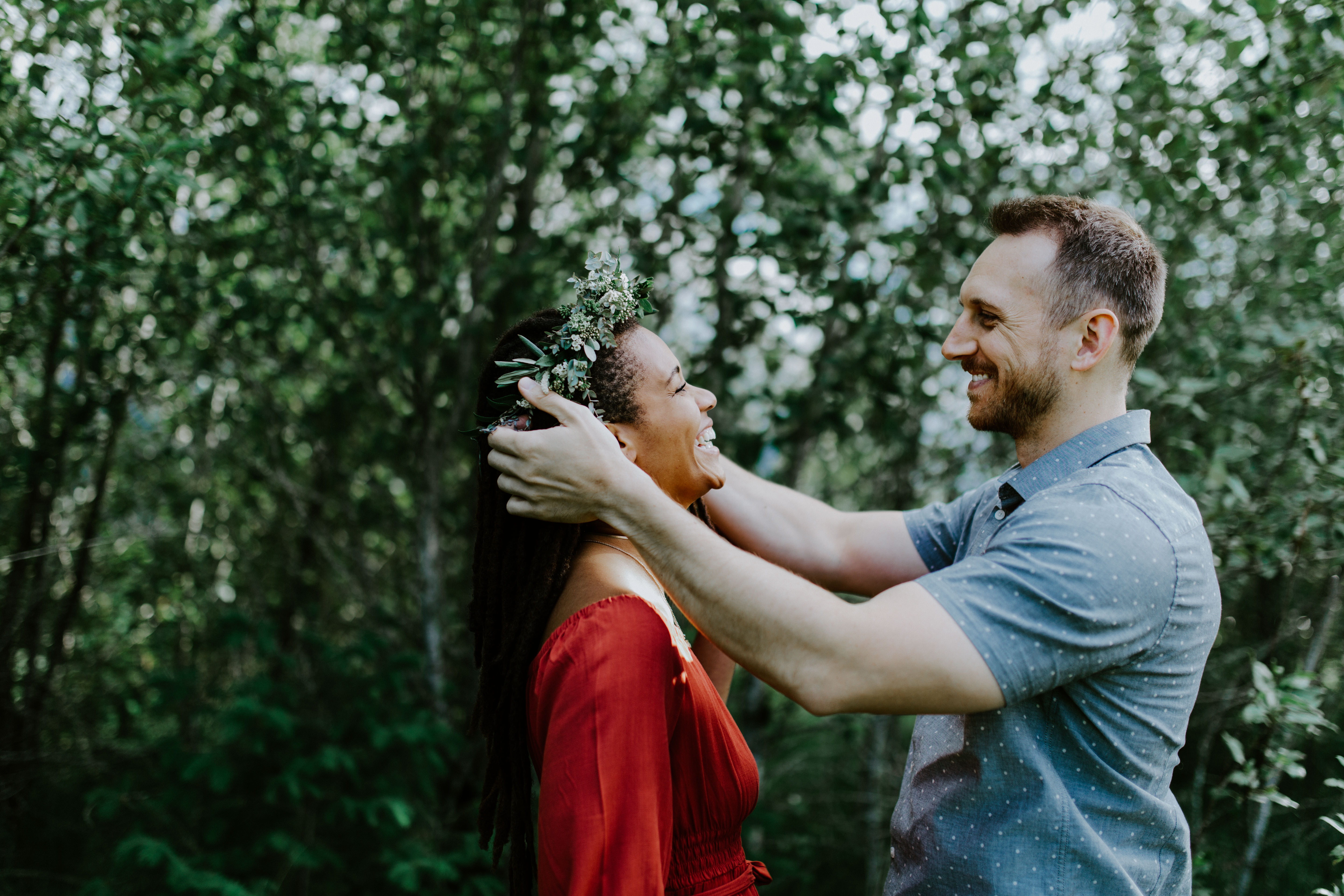 Garrett places a flower crown on Kayloni at Cascade Locks in Oregon during their elopement. Engagement photography in Portland Oregon by Sienna Plus Josh.