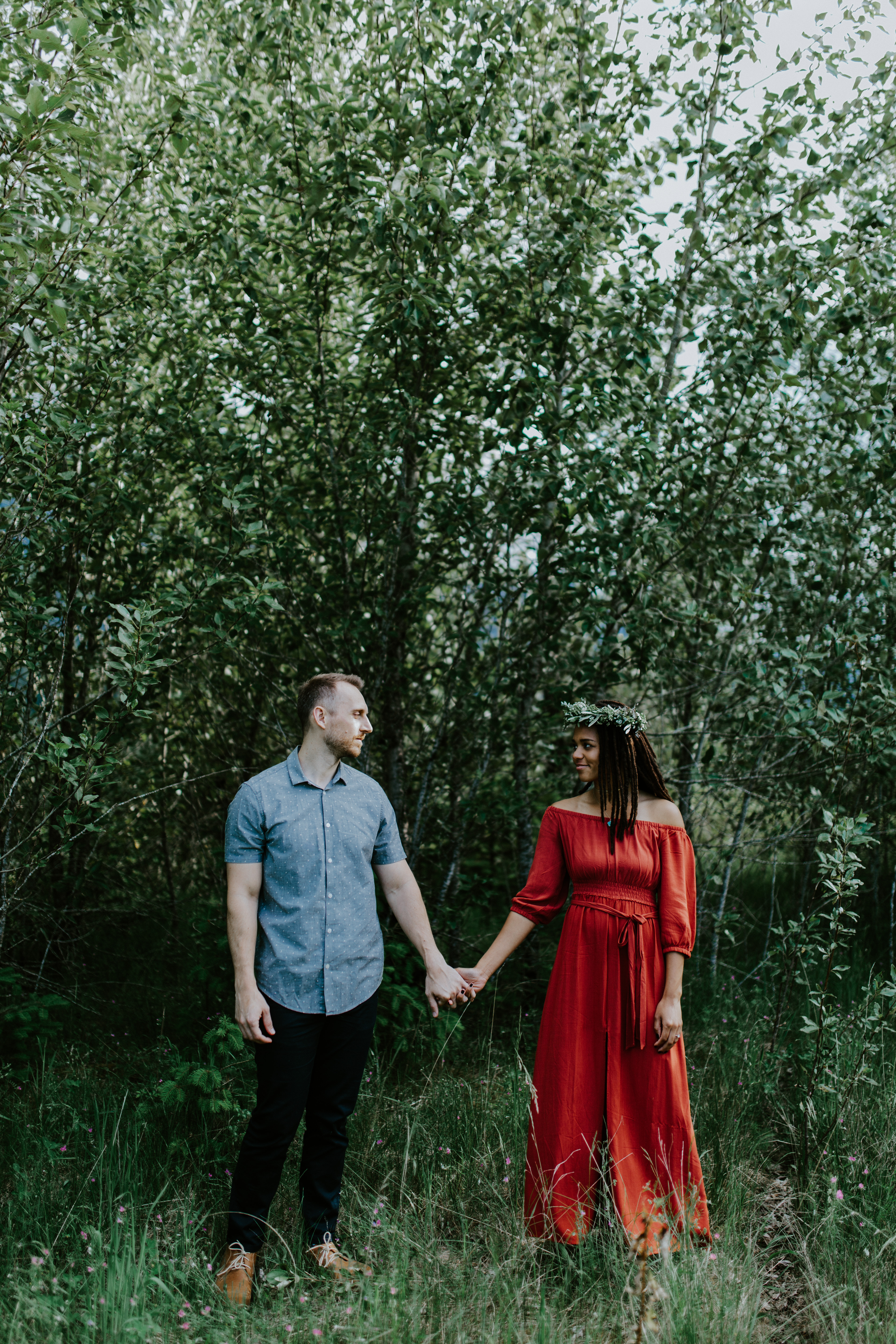Kayloni and Garrett stand side by side near the trees of Cascade Locks, Oregon during her Oregon coast elopement. Engagement photography in Portland Oregon by Sienna Plus Josh.