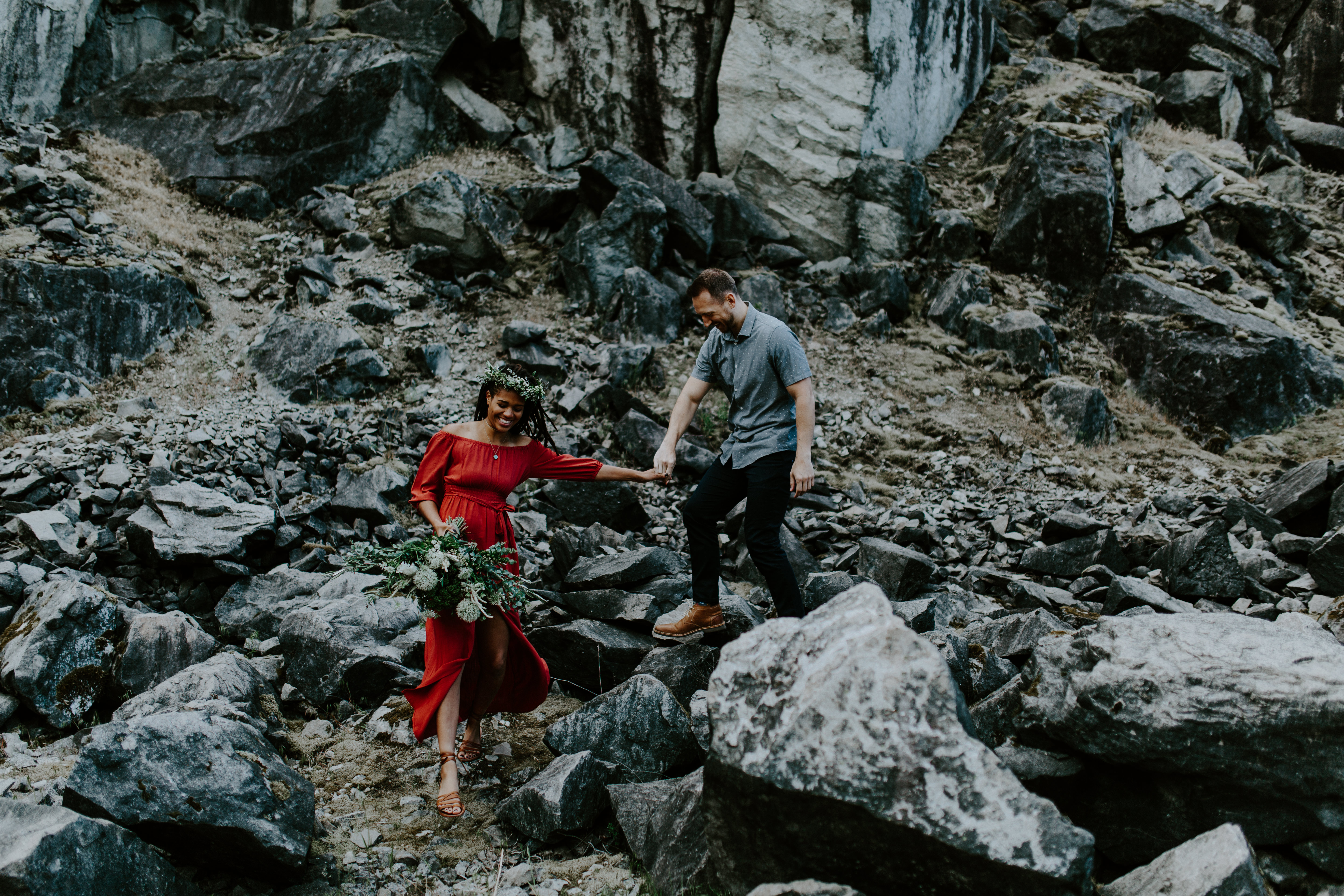 Kayloni and Garrett make their way down the rocks at the Columbia River Gorge in Oregon. Engagement photography in Portland Oregon by Sienna Plus Josh.