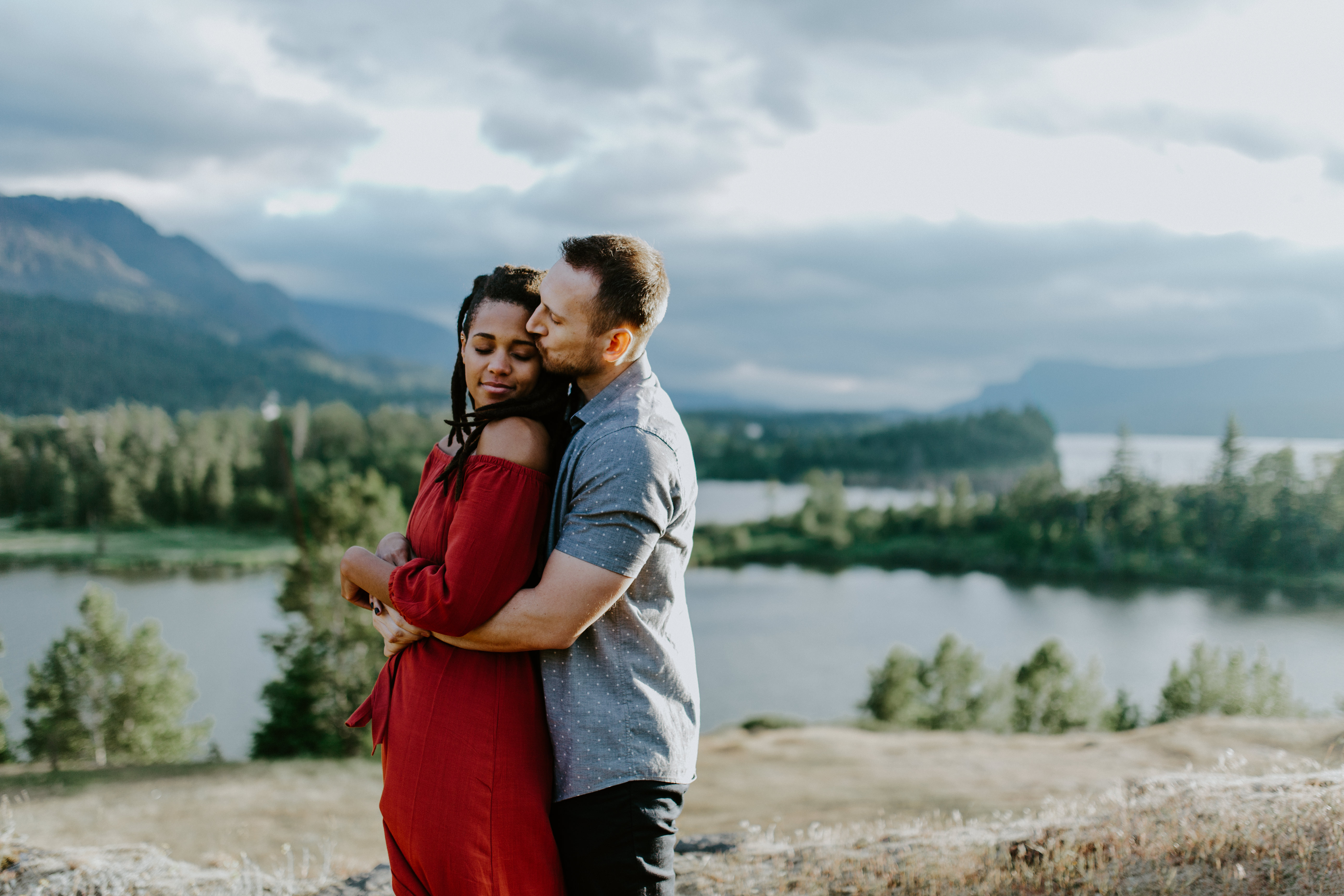 Garrett holds Kayloni hug at Cascade Locks in Oregon. Engagement photography in Portland Oregon by Sienna Plus Josh.
