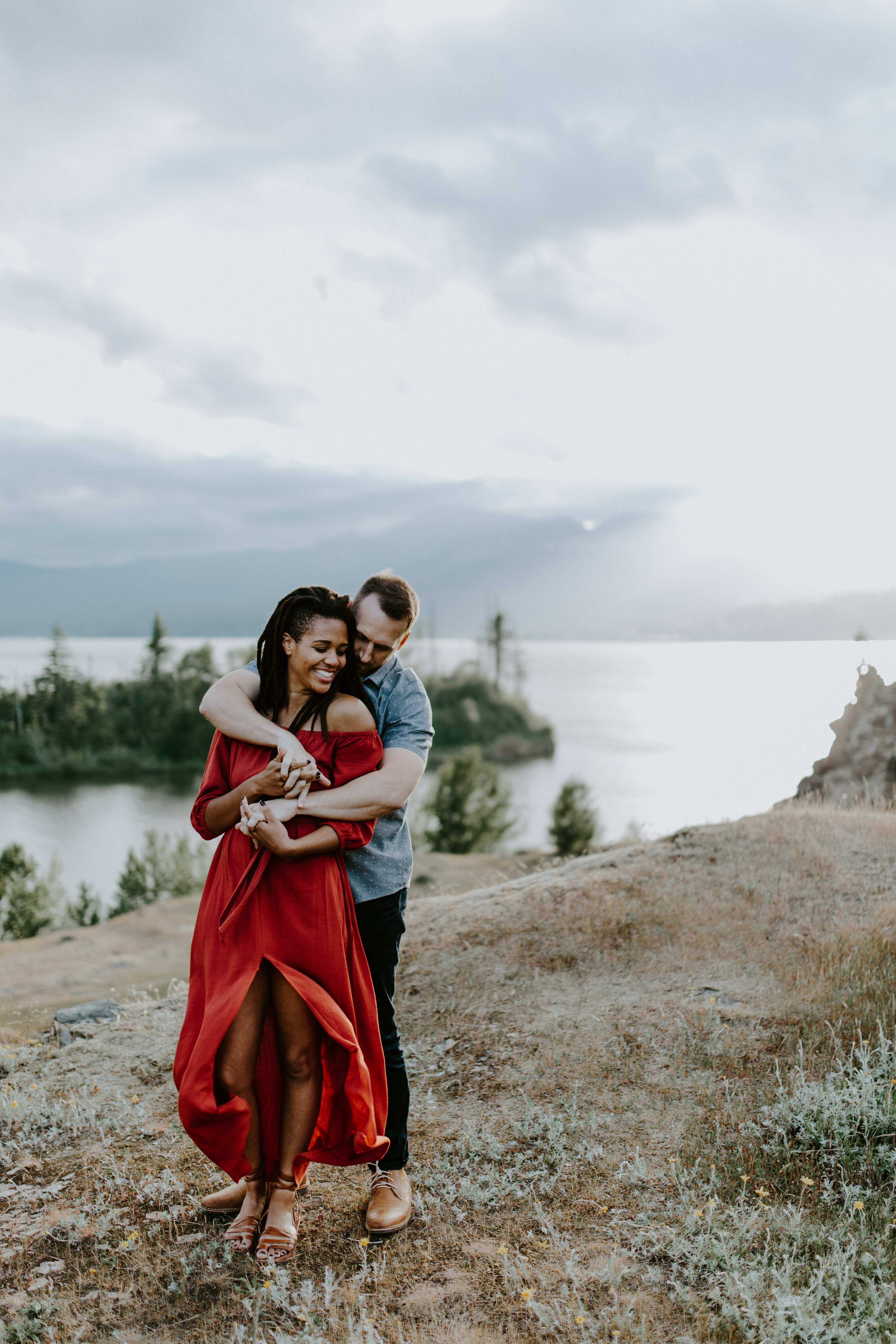 Kayloni and Garrett stand in front of the Columbia River Gorge, Oregon. Engagement photography in Portland Oregon by Sienna Plus Josh.