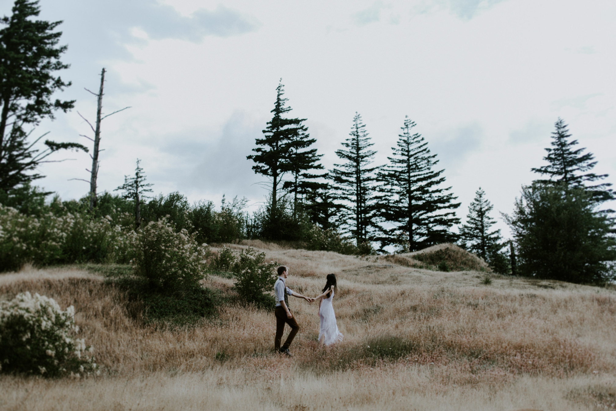 Jacob and Kimberlie hold hands. Elopement wedding photography at Cascade Locks by Sienna Plus Josh.