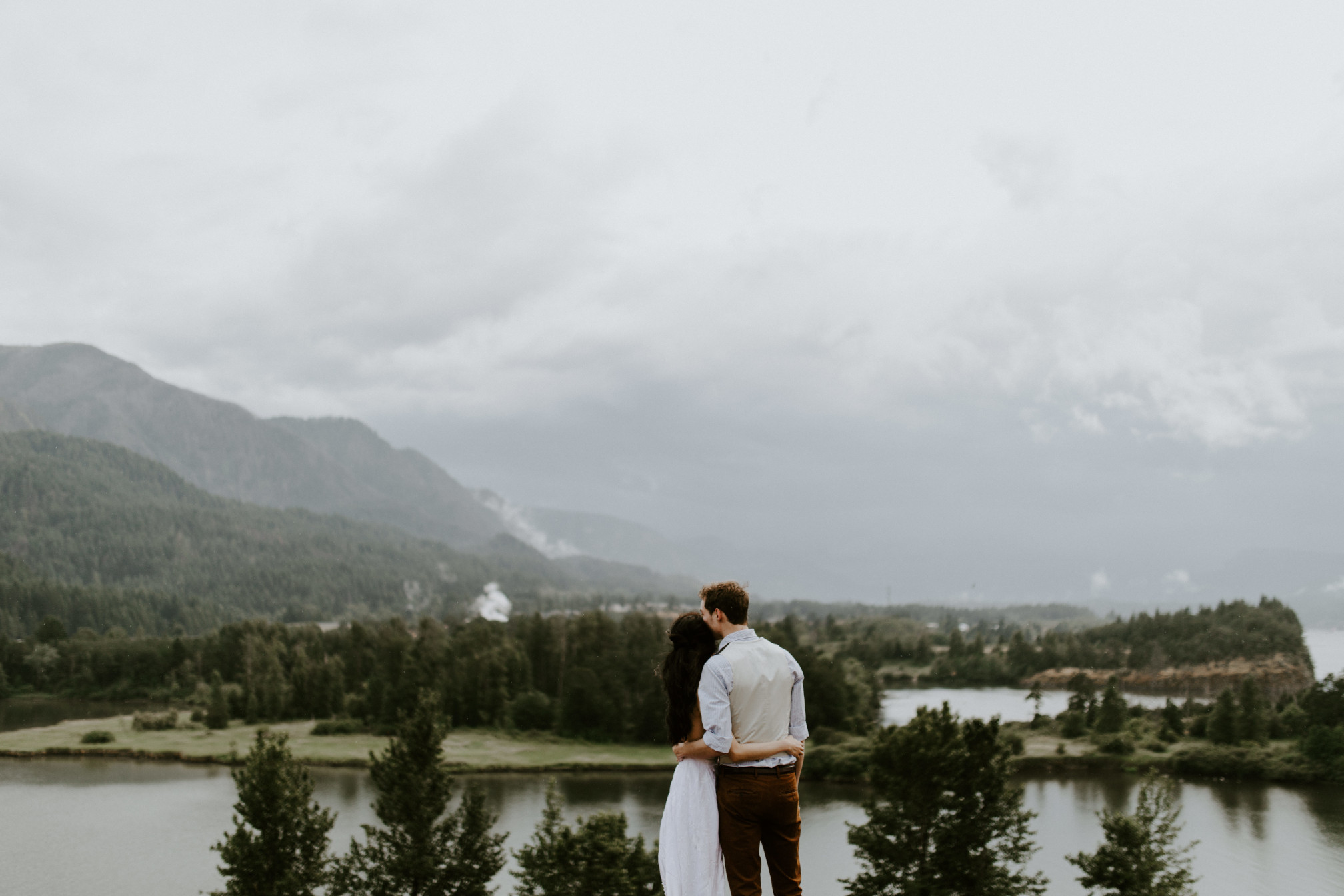 Jacob and Kimberlie stand and admire the view of the Columbia River Gorge. Elopement wedding photography at Cascade Locks by Sienna Plus Josh.