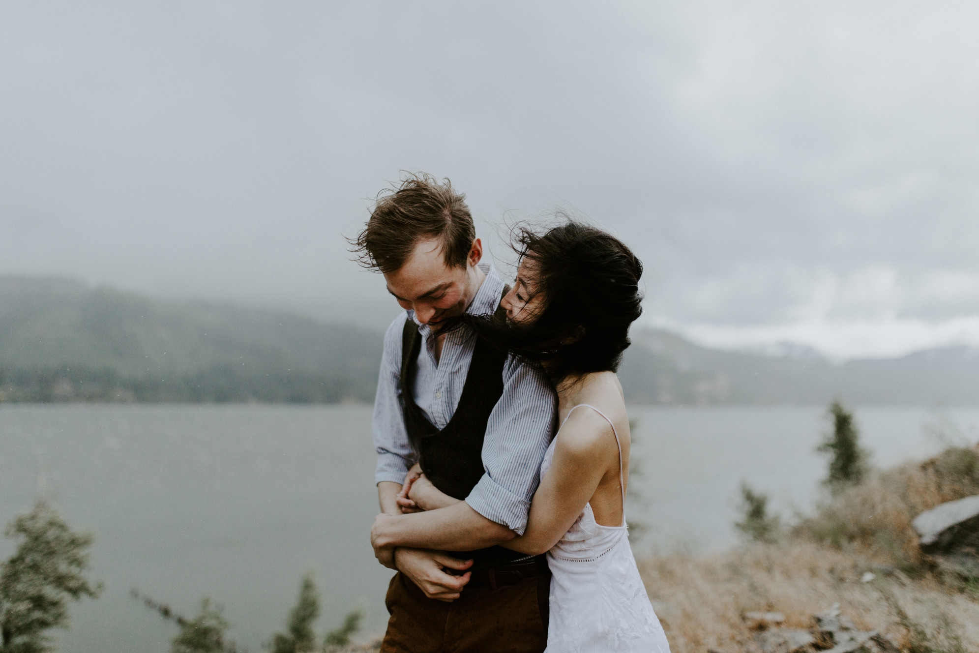 Kimberlie holds onto Jacob while smiling. Elopement wedding photography at Cascade Locks by Sienna Plus Josh.