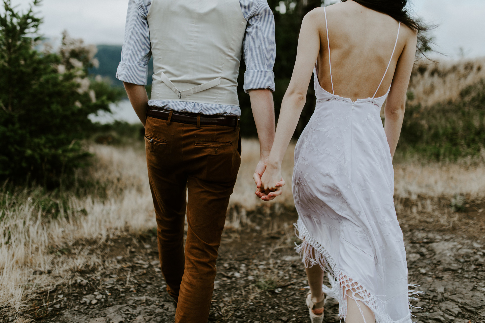 Jacob and Kimberlie walk hand in hand. Elopement wedding photography at Cascade Locks by Sienna Plus Josh.