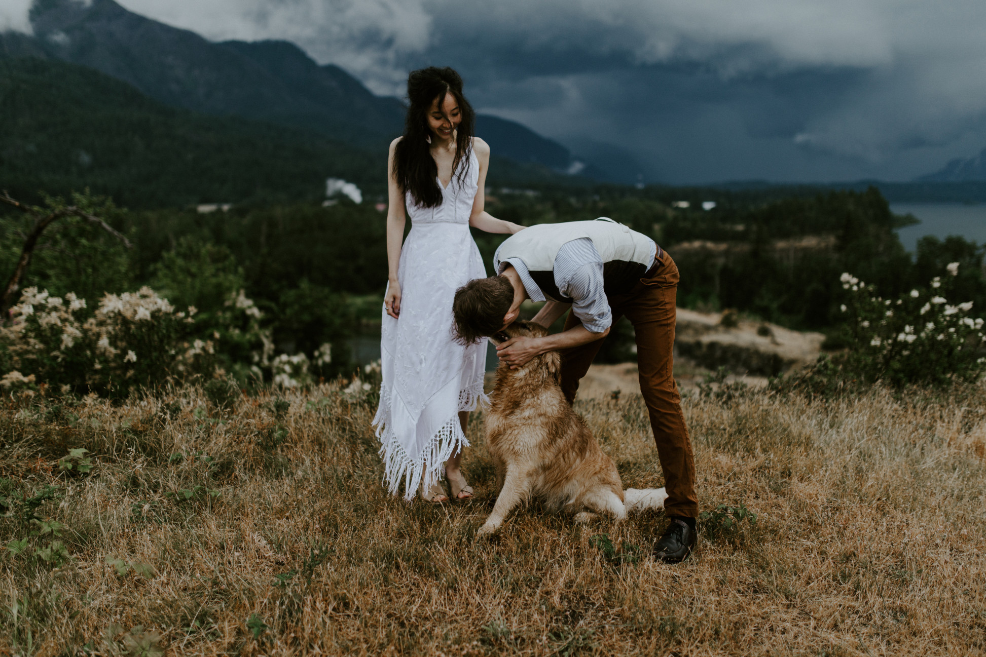 Kimberlie and Jacob admire their dog Cody at Cascade Locks, OR. Elopement wedding photography at Cascade Locks by Sienna Plus Josh.