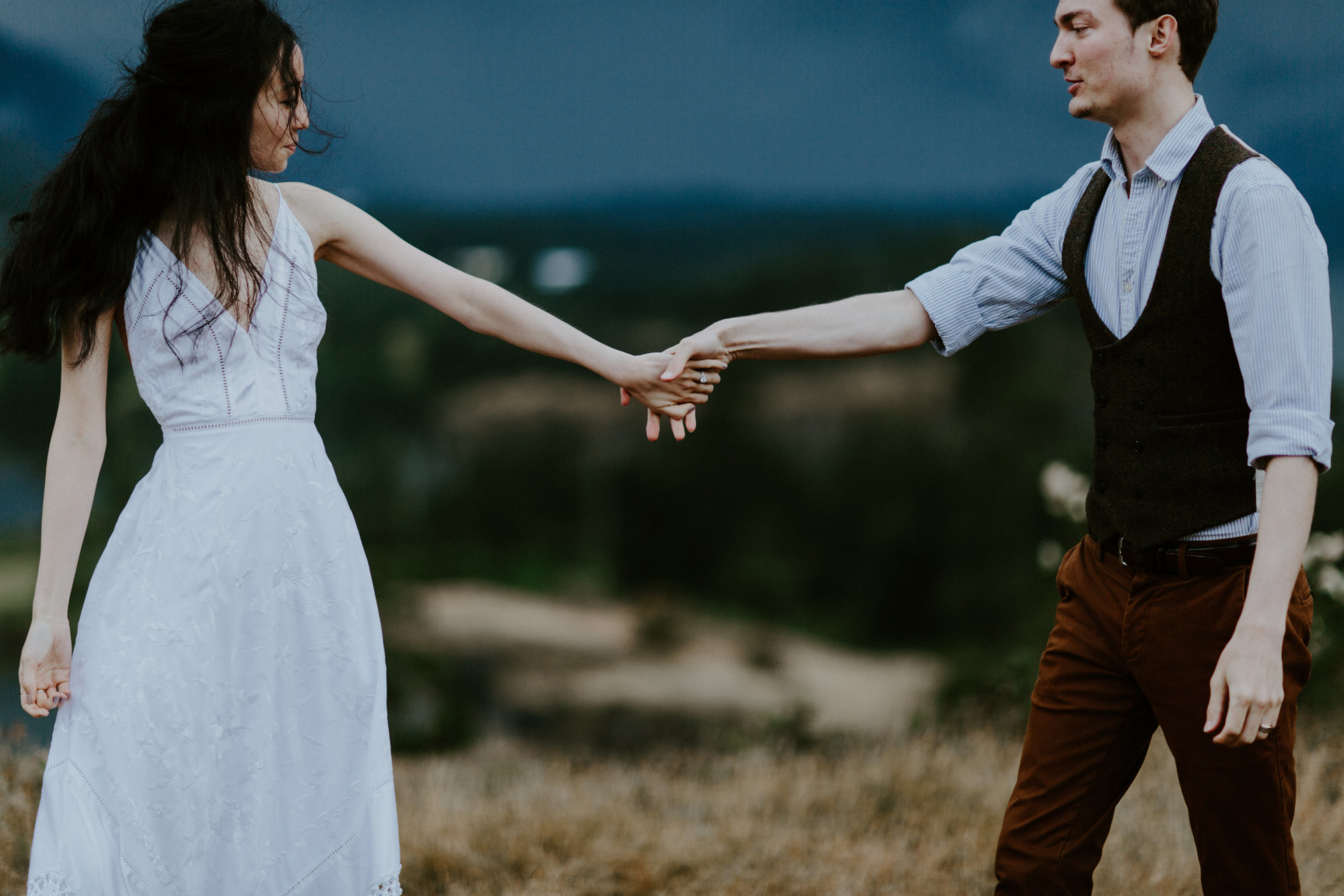 Kimberlie and Jacob hold hands. Elopement wedding photography at Cascade Locks by Sienna Plus Josh.