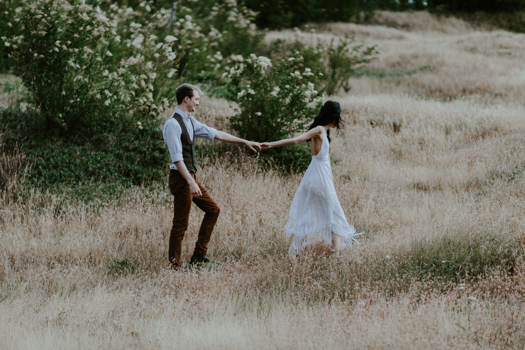 Jacob and Kimberlie walk through the grass at Cascade Locks, OR. Elopement wedding photography at Cascade Locks by Sienna Plus Josh.