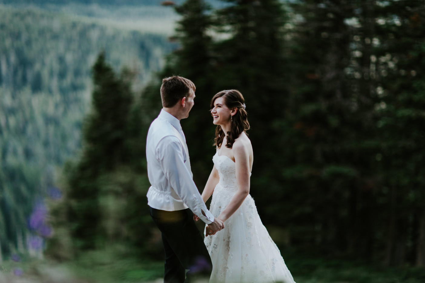 Moira and Ryan smile at eachother near the view at Mount Hood. Adventure elopement wedding shoot by Sienna Plus Josh.